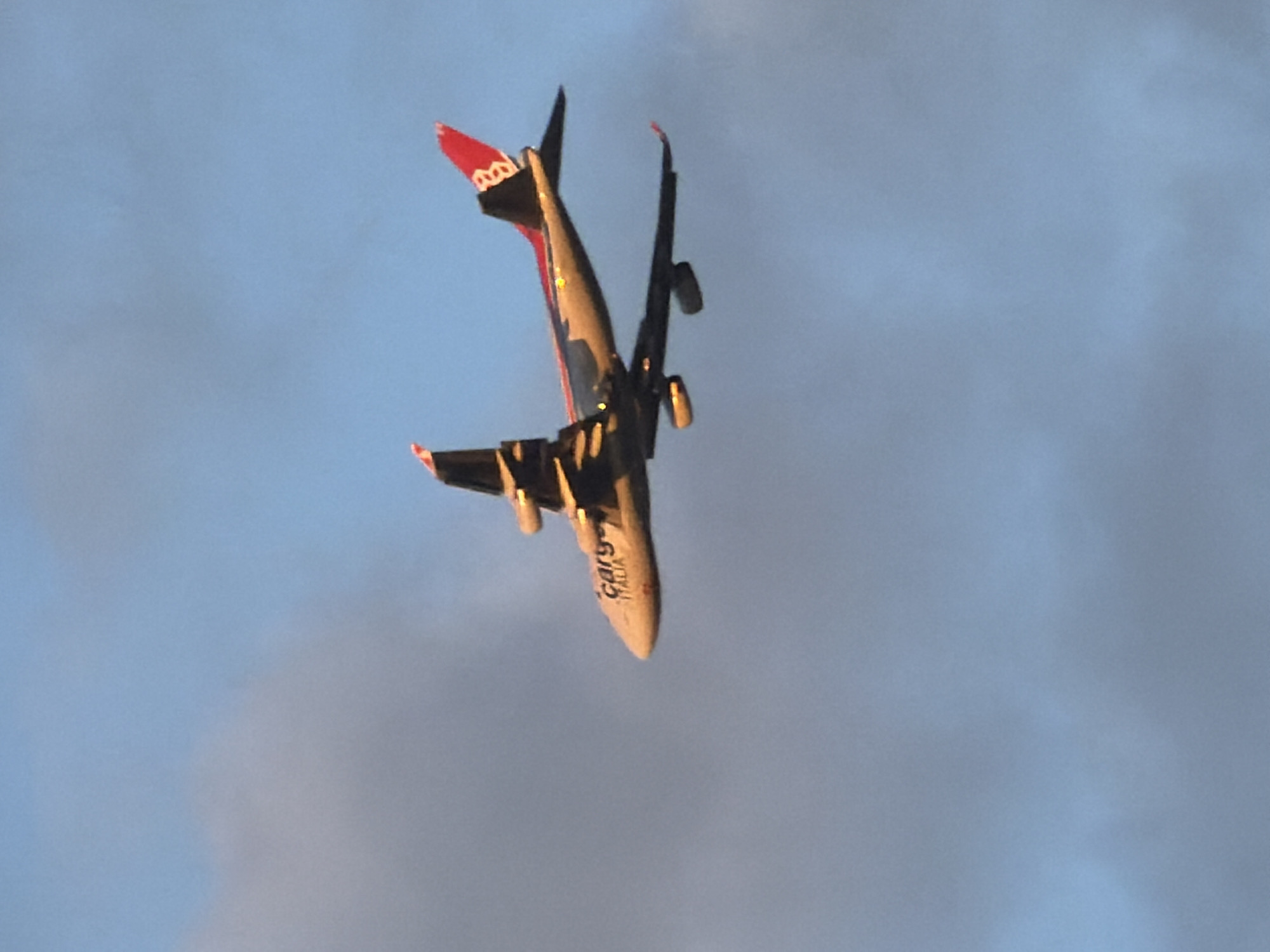 Dusk over Esch-sur-Alzette, skies, rooftops, and a passing cargo jet