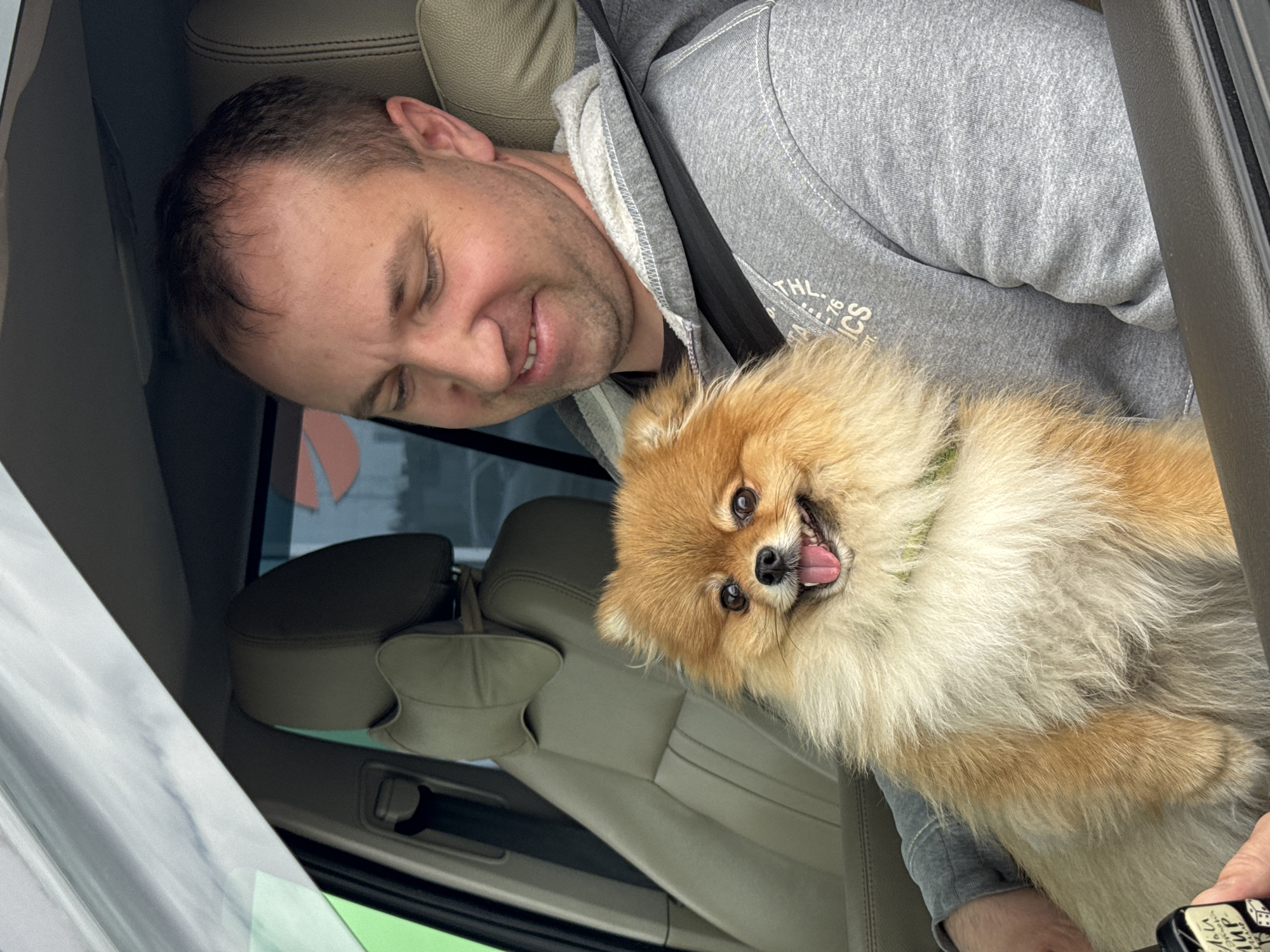 Man with Pomeranian dog visits cafe area in Medovoye, Russia