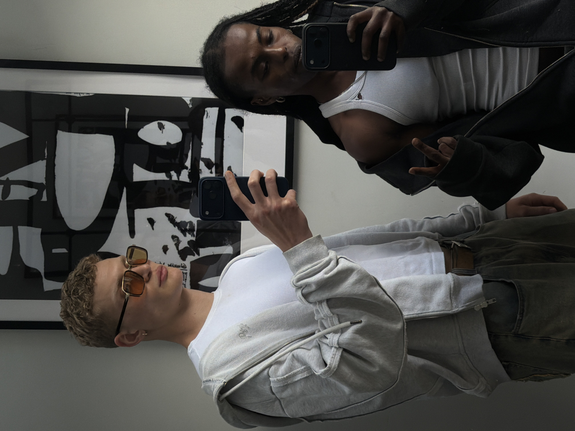 Mirror selfie with abstract artwork in London interior