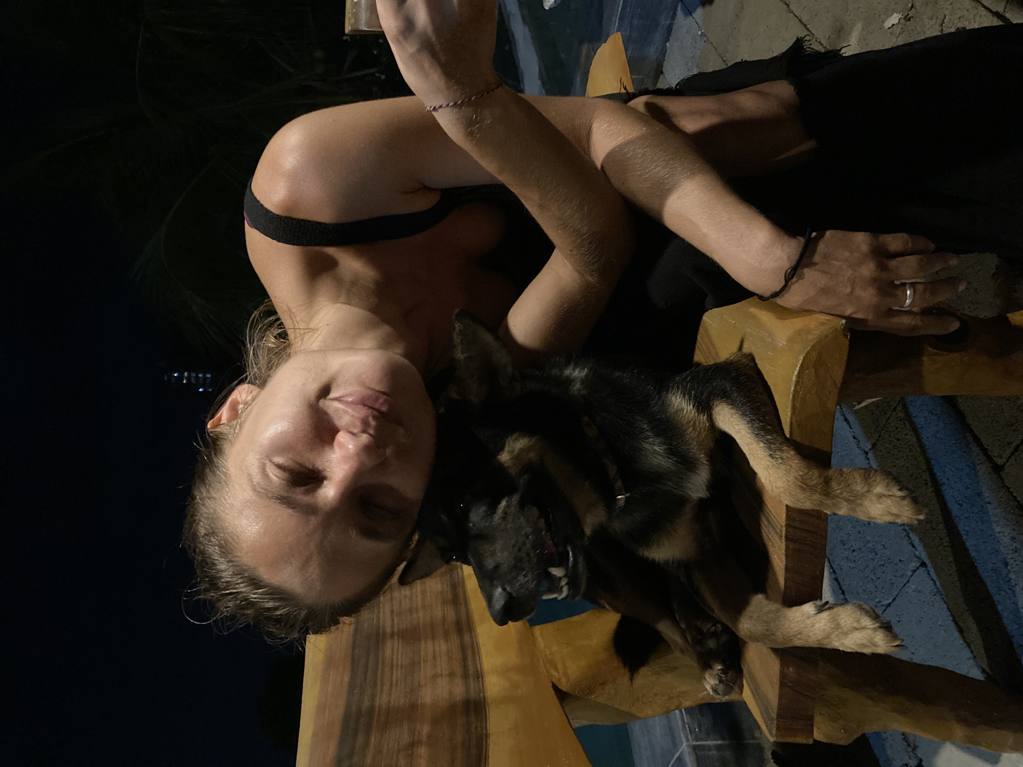 Woman with German Shepherd captured indoors at night in Mũi Né