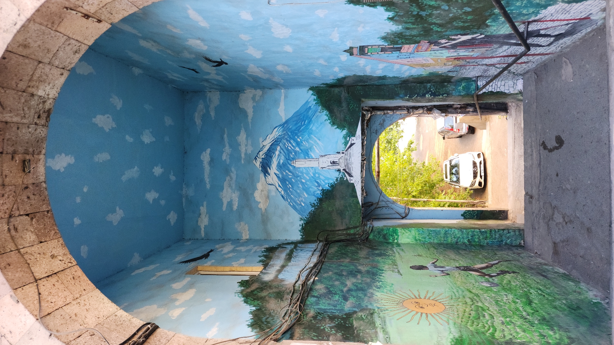 Street-level Yerevan: murals, stone architecture, and a sleeping dog
