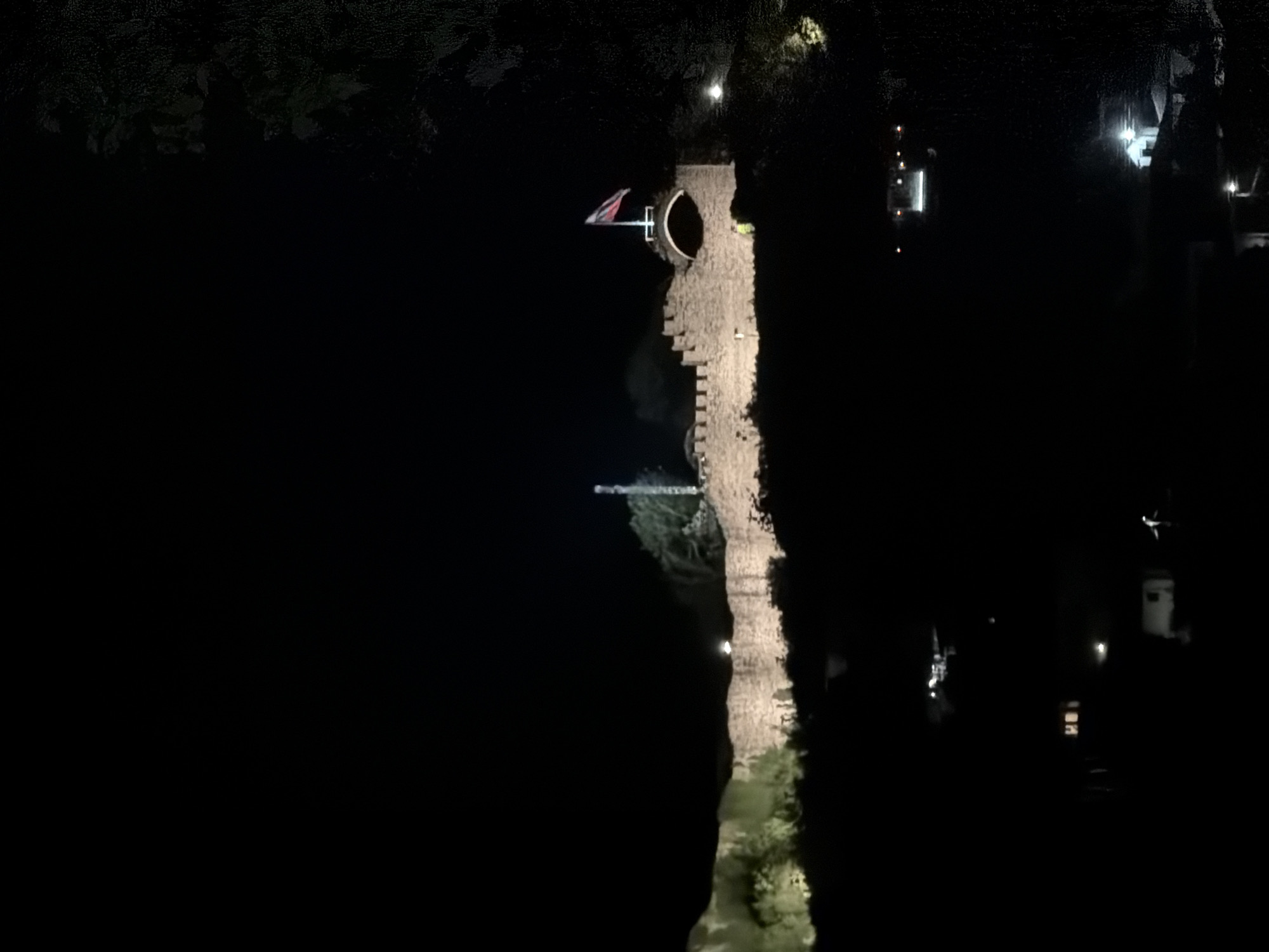 Medieval castle illuminated at night captured by witnesses