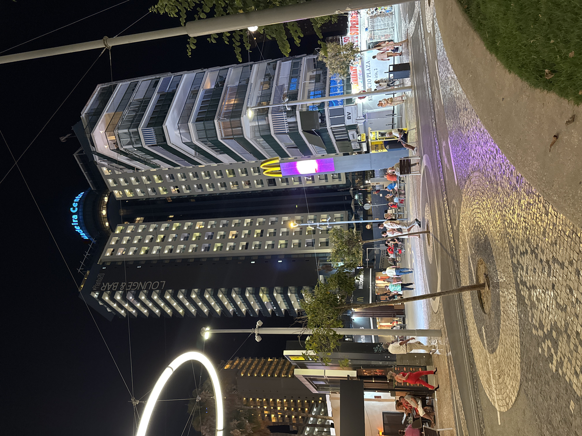 Benidorm promenade at night: arcades, lights, and street life