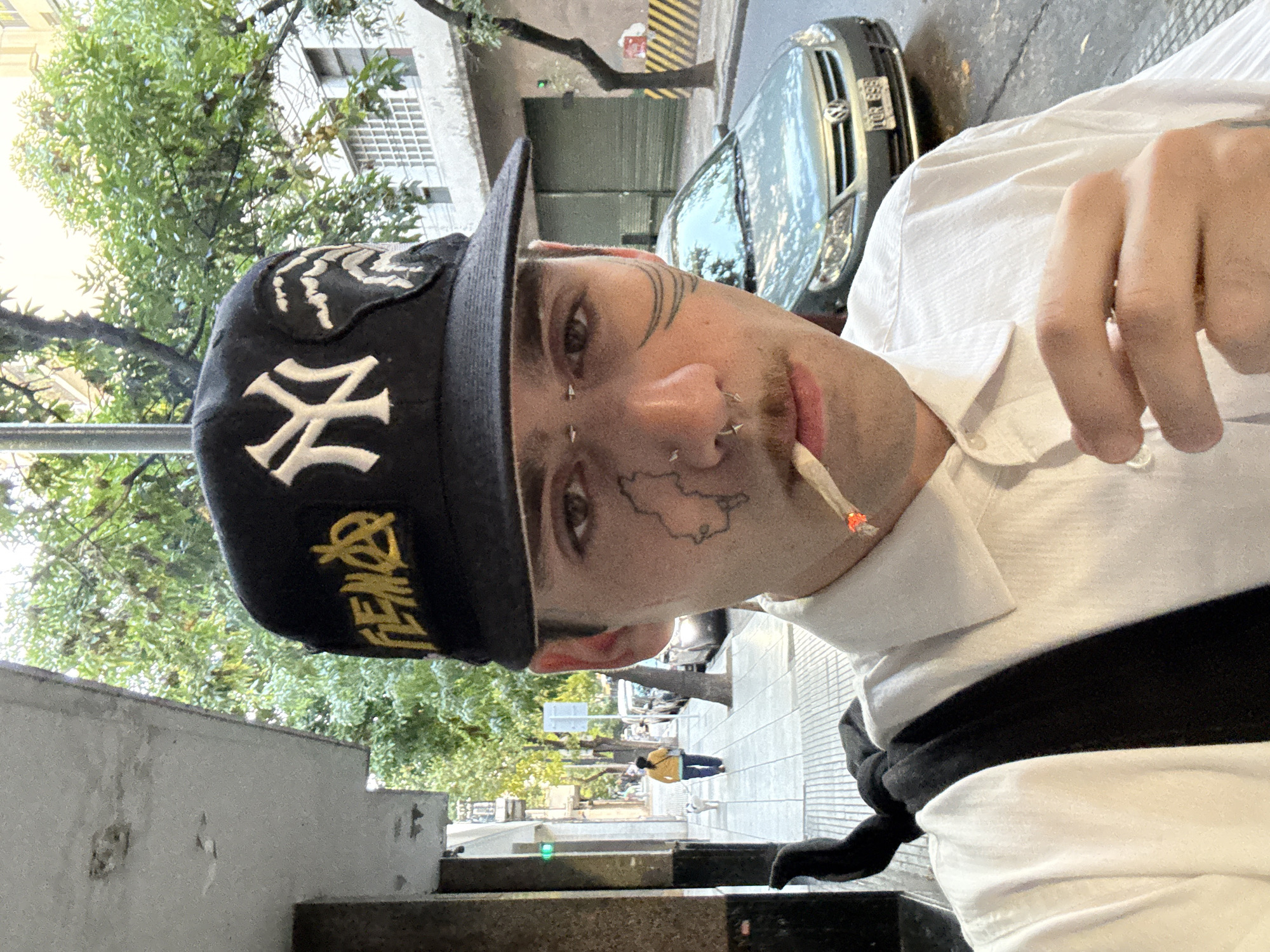 Tattooed youth spotted smoking in Buenos Aires wearing Yankees cap