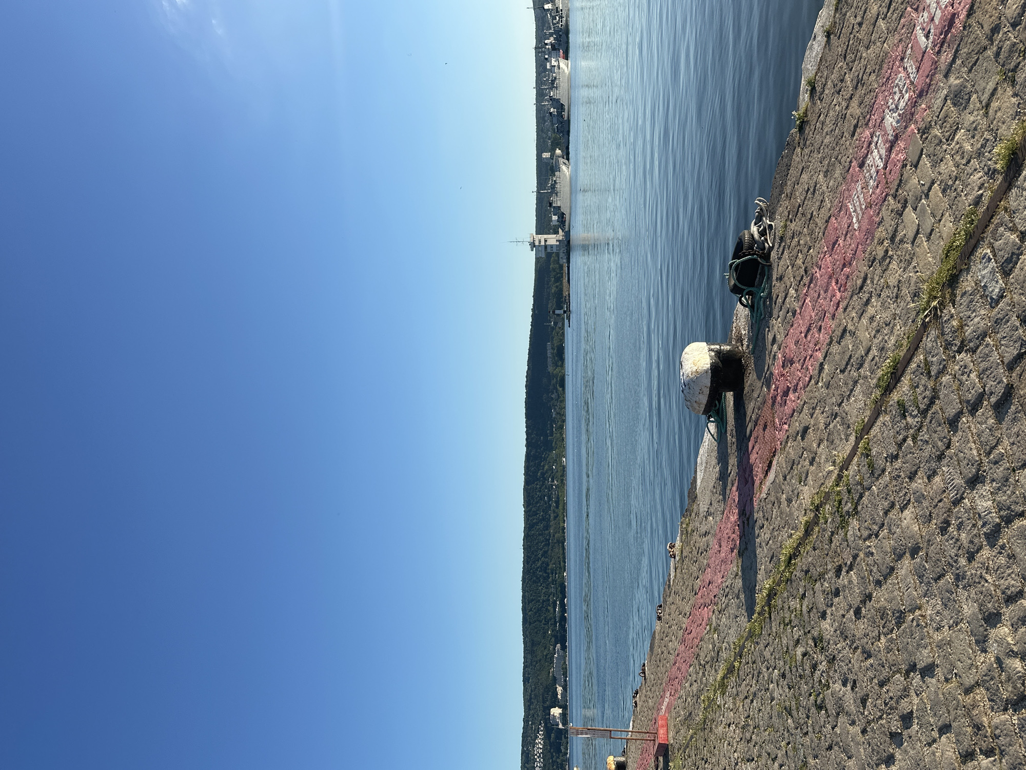 Harbor walkthrough during golden hour with boats and breakwater