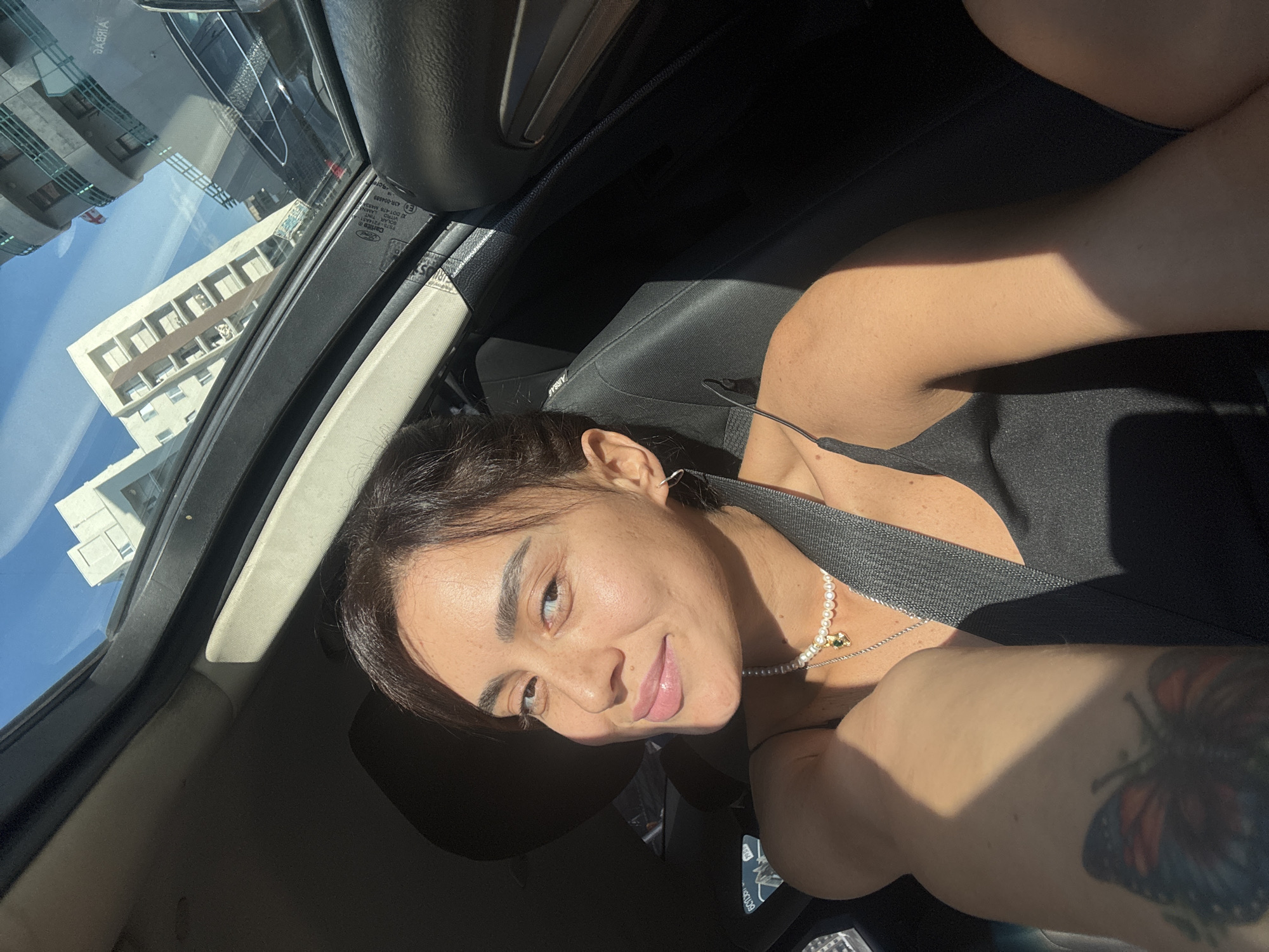 Sunlit moment in a car with open sunroof, Tbilisi