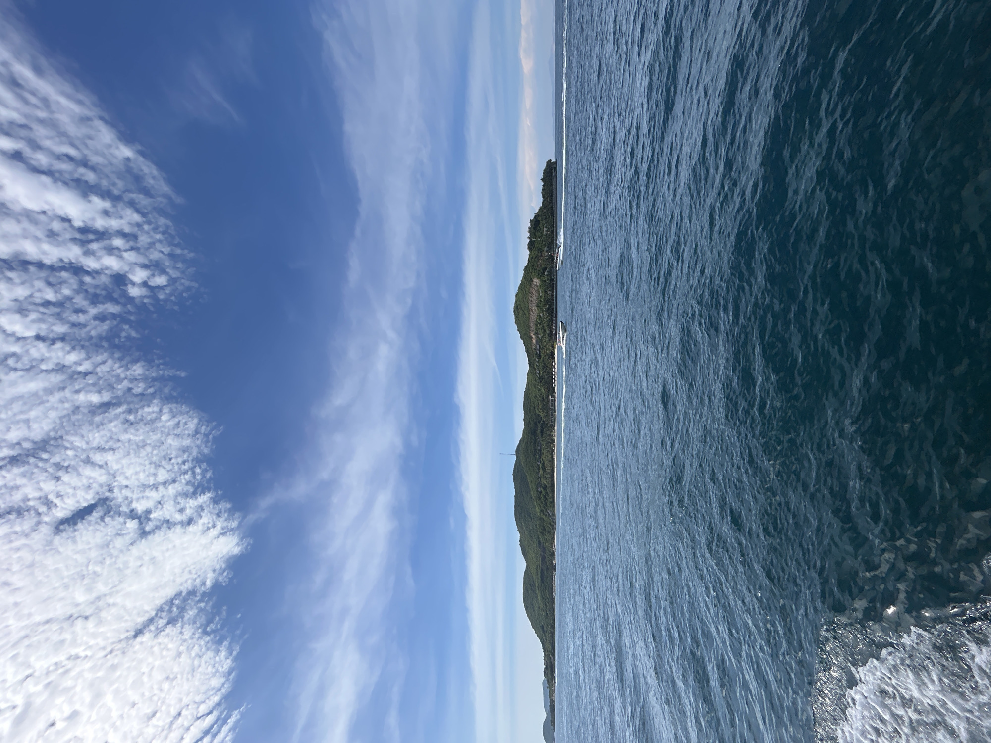 Motorboat crossing open water off Nha Trang's island coastline