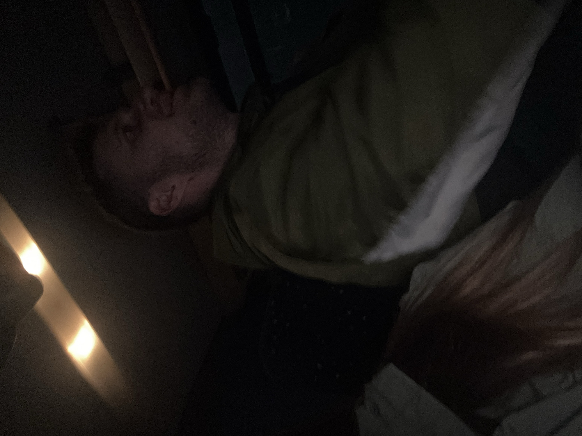 Man resting in dim lighting observed in Łódź