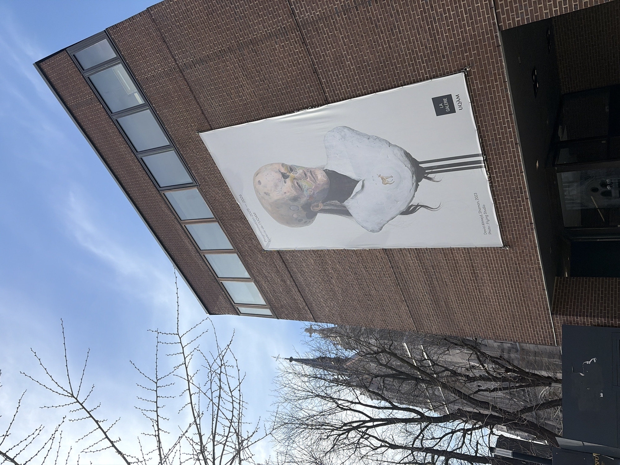 Montreal moments: Art exhibition poster and visitor at basilica