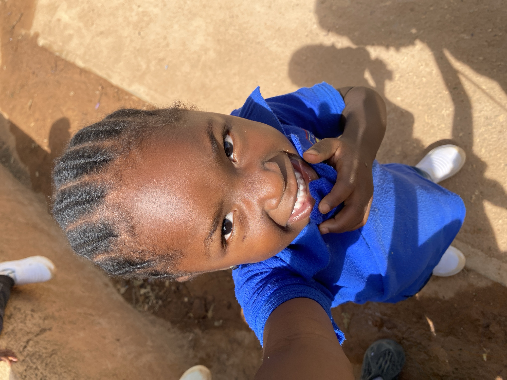 Nigerian schoolchildren pose for photos during playground time