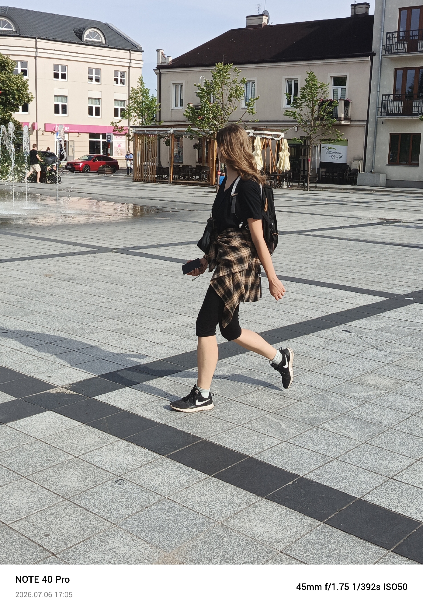 Afternoon foot traffic through central Piaseczno on a sunny day