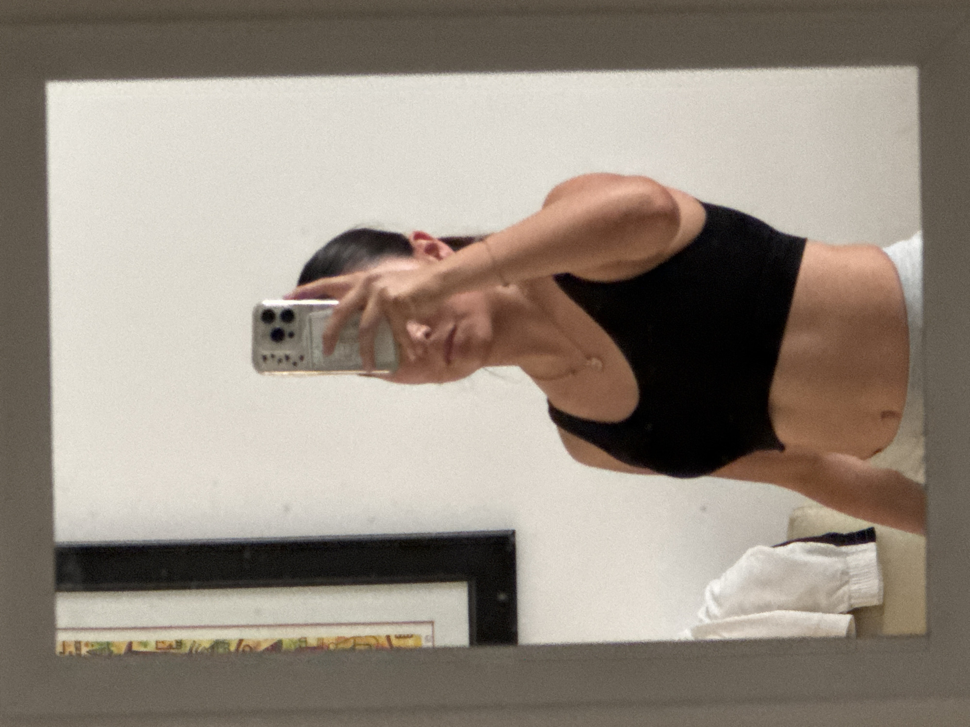 Woman takes mirror selfie in indoor space in Ocotlán
