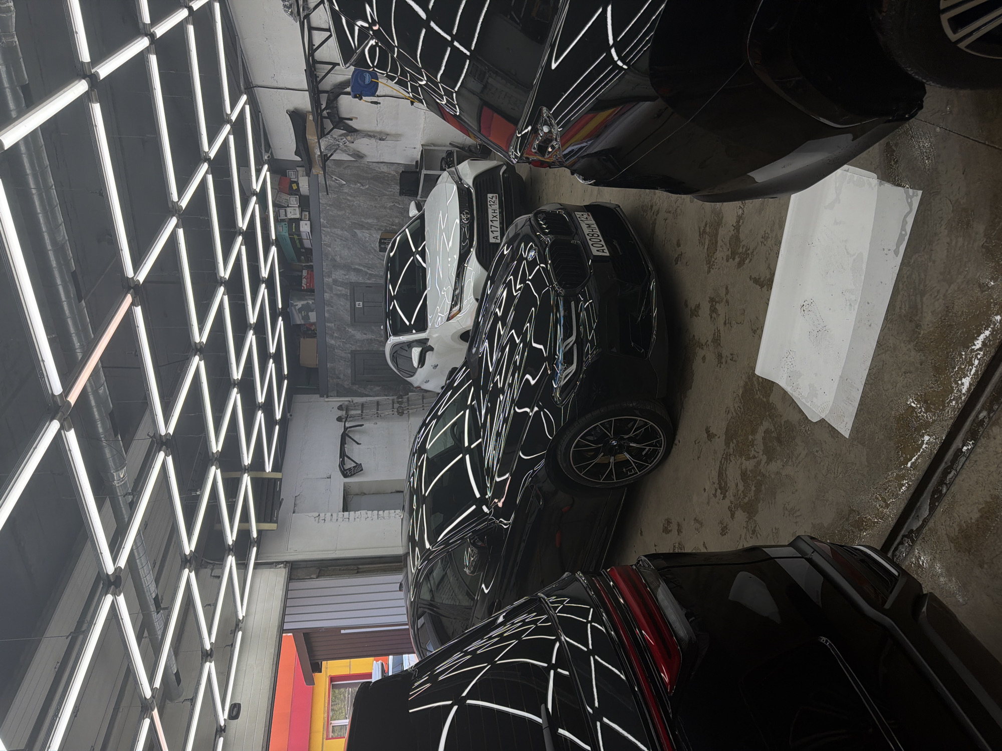 Busy detailing session on multiple black cars in Krasnoyarsk