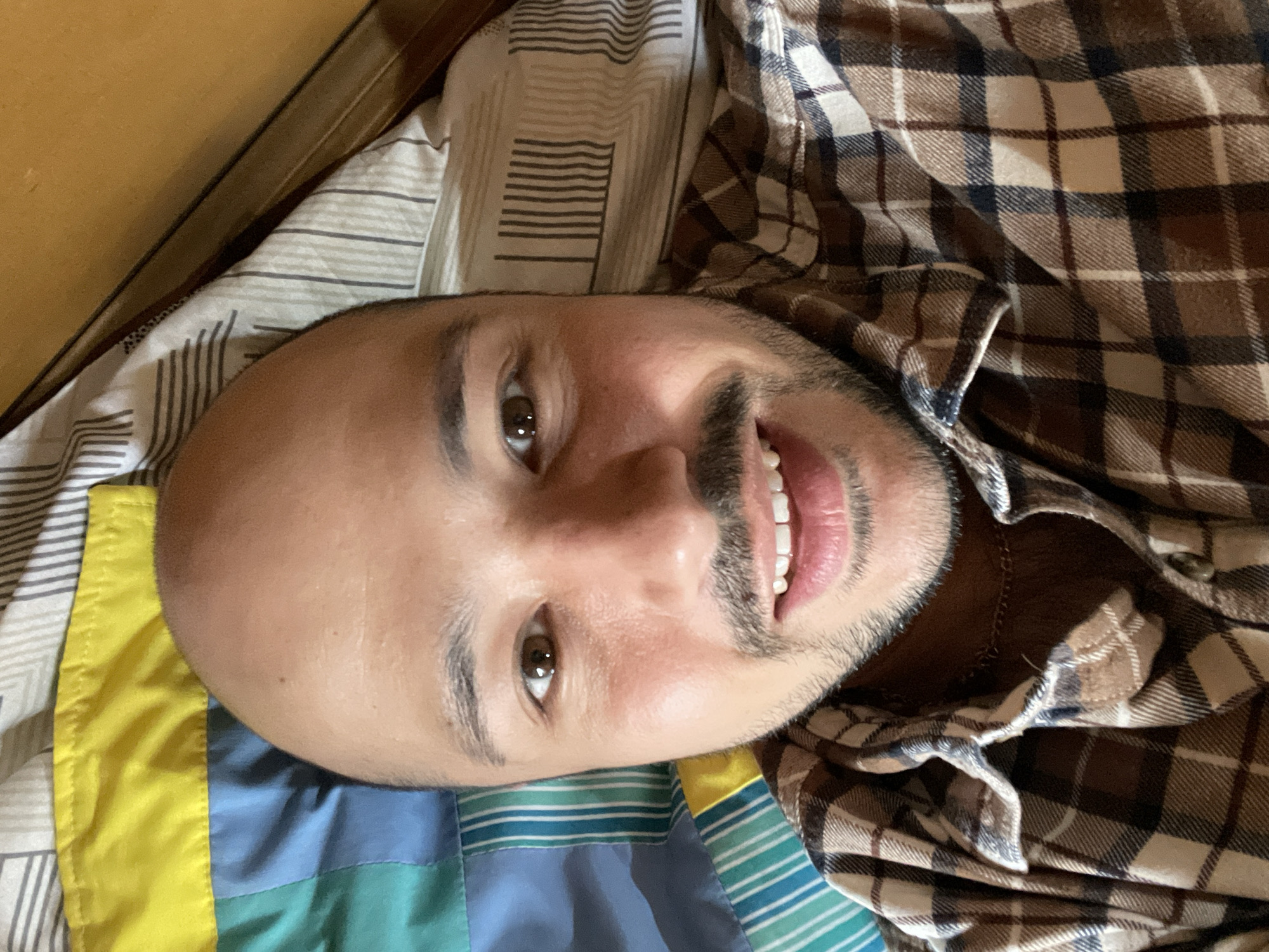 Man takes selfie on bed in Zav'yalovo, Russia