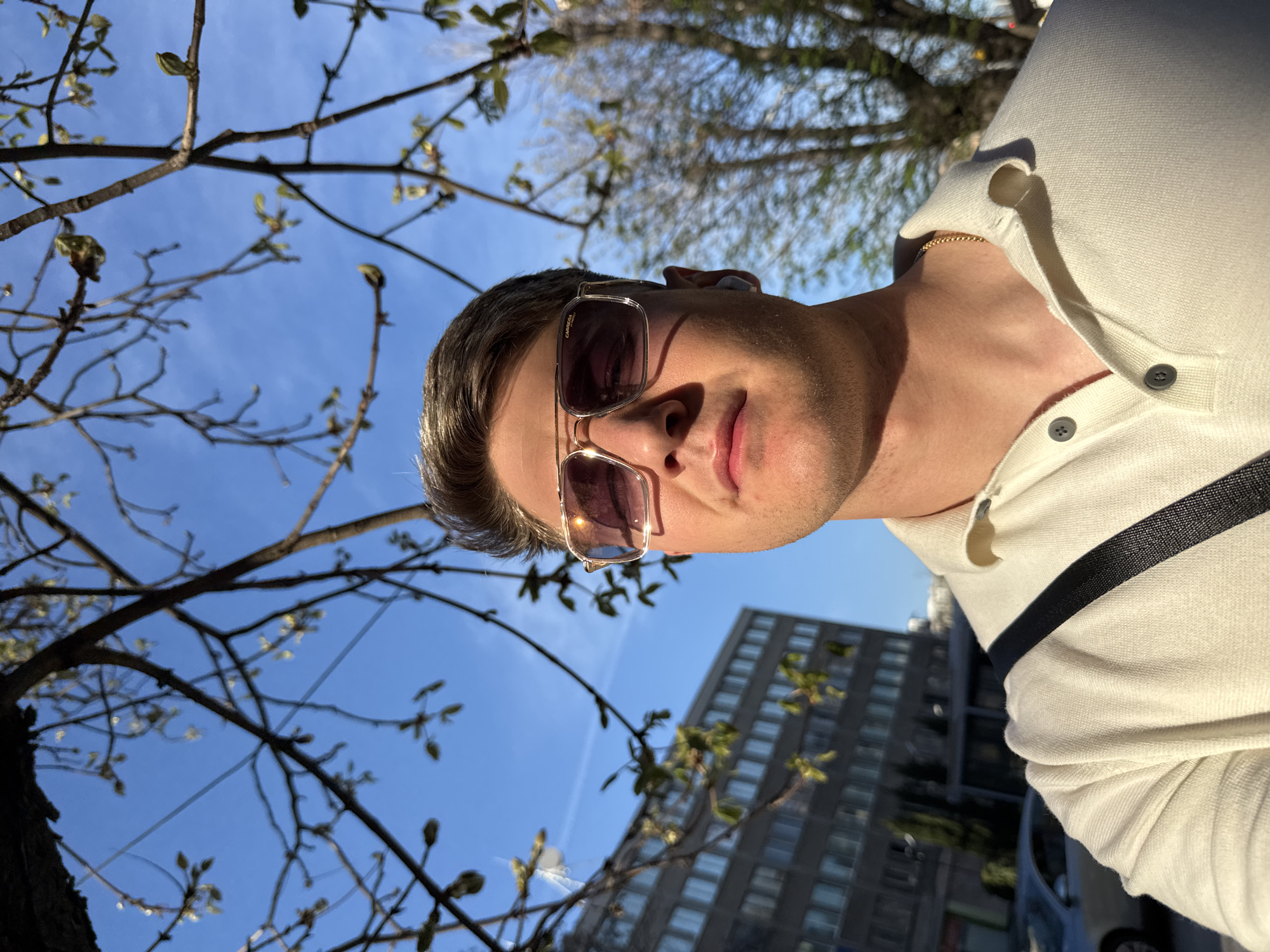 Man takes selfies on sunny Plovdiv sidewalk
