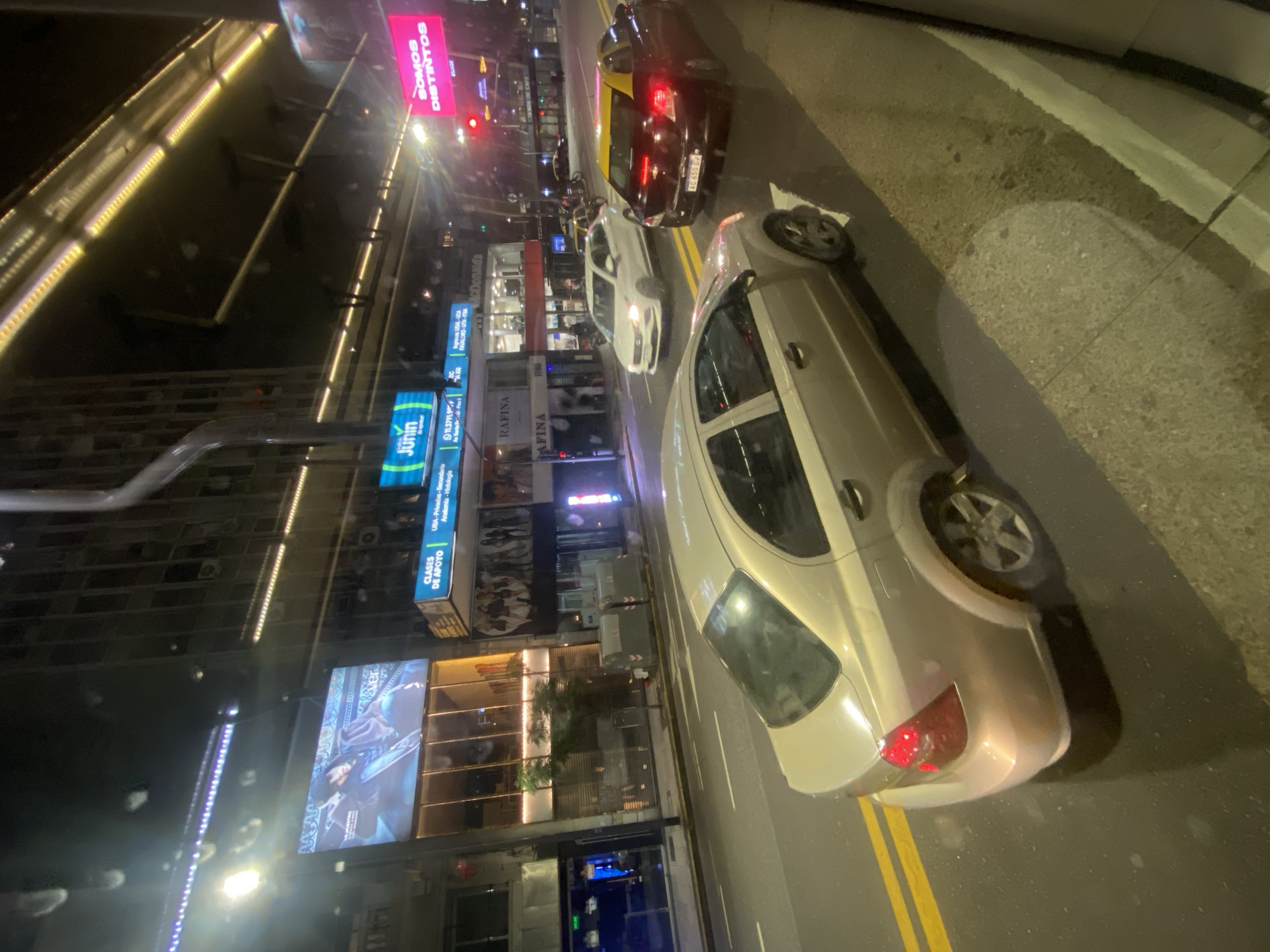 Nighttime street scene captured in Buenos Aires with McDonald's visible