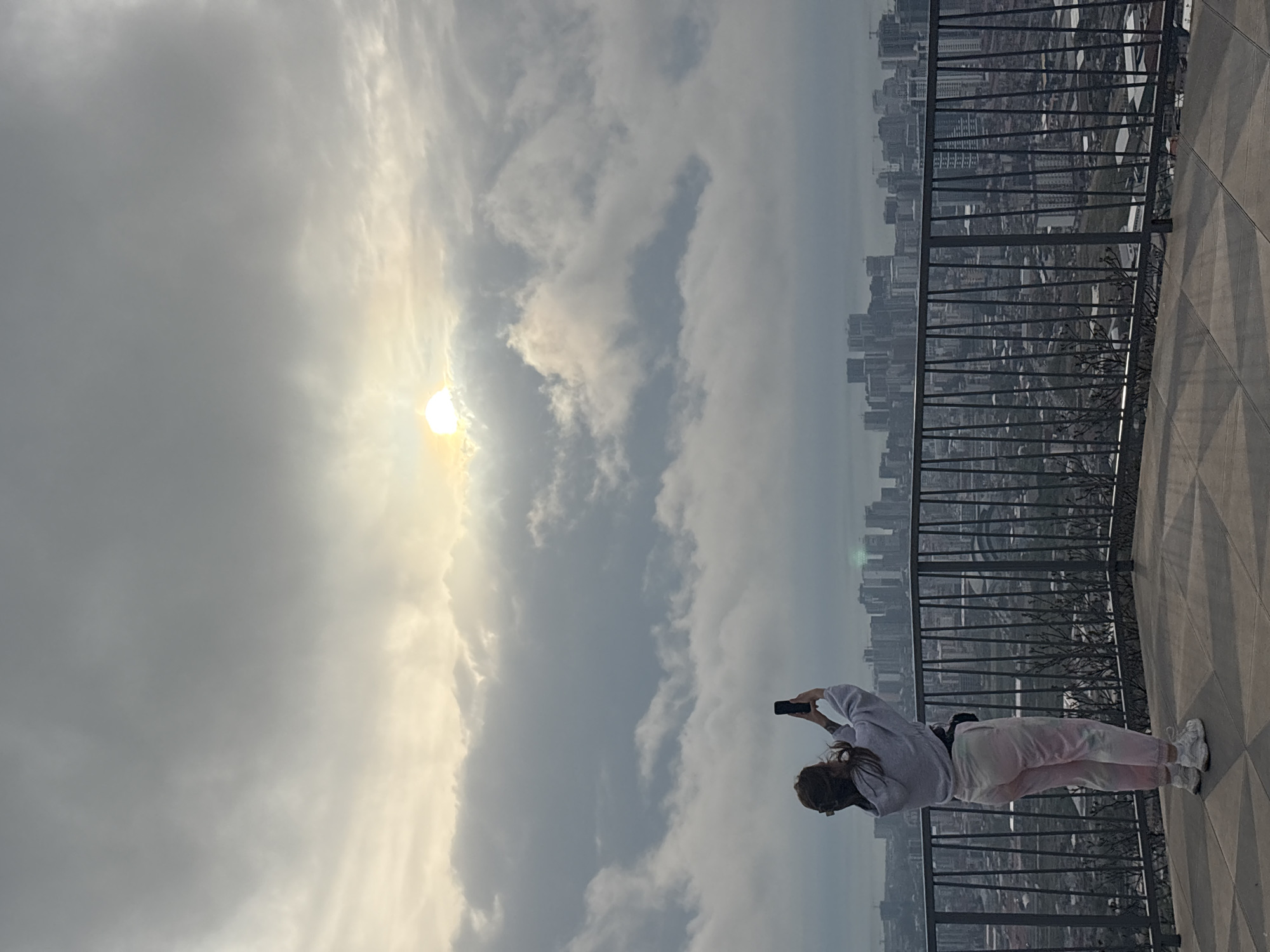 Tourist photographs cloudy cityscape from Batumi observation deck