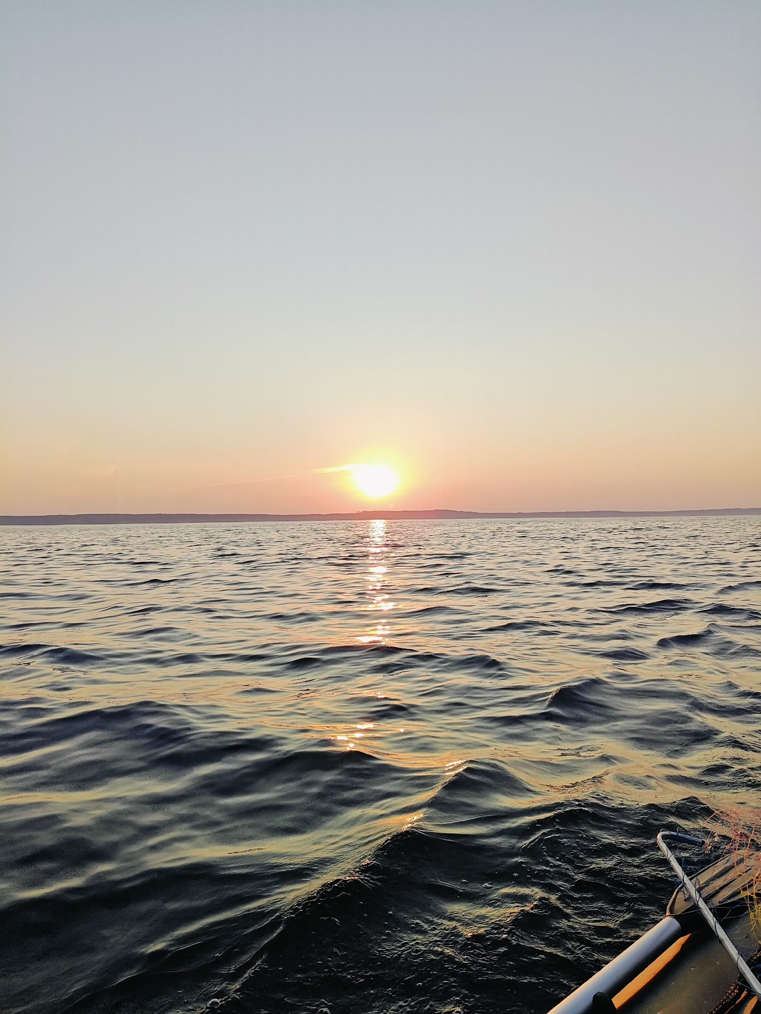 Summer sunset over calm Russian lake waters