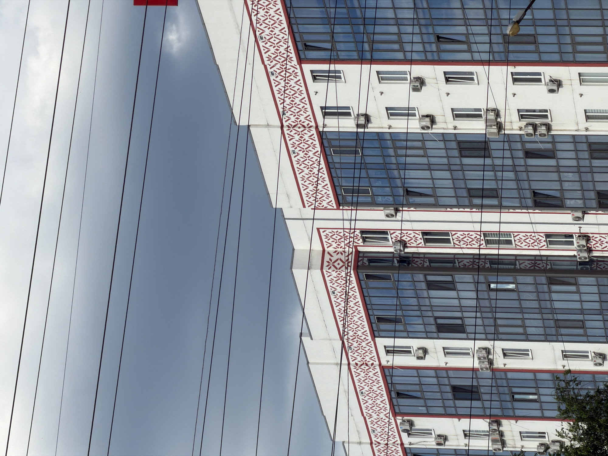 Urban street-level snapshots: apartments, wires, and a hot tub on a trailer