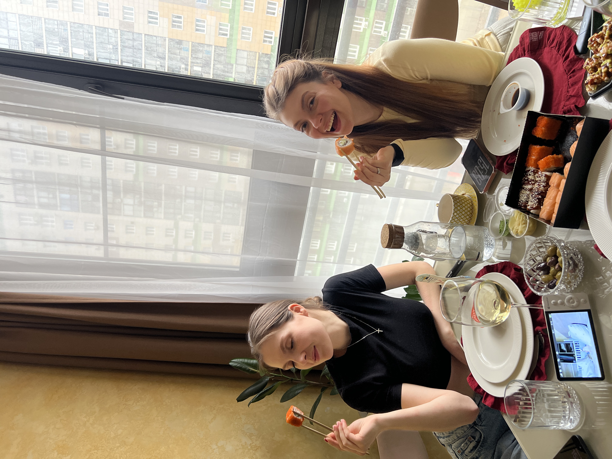 Two women share meal in Khimki apartment