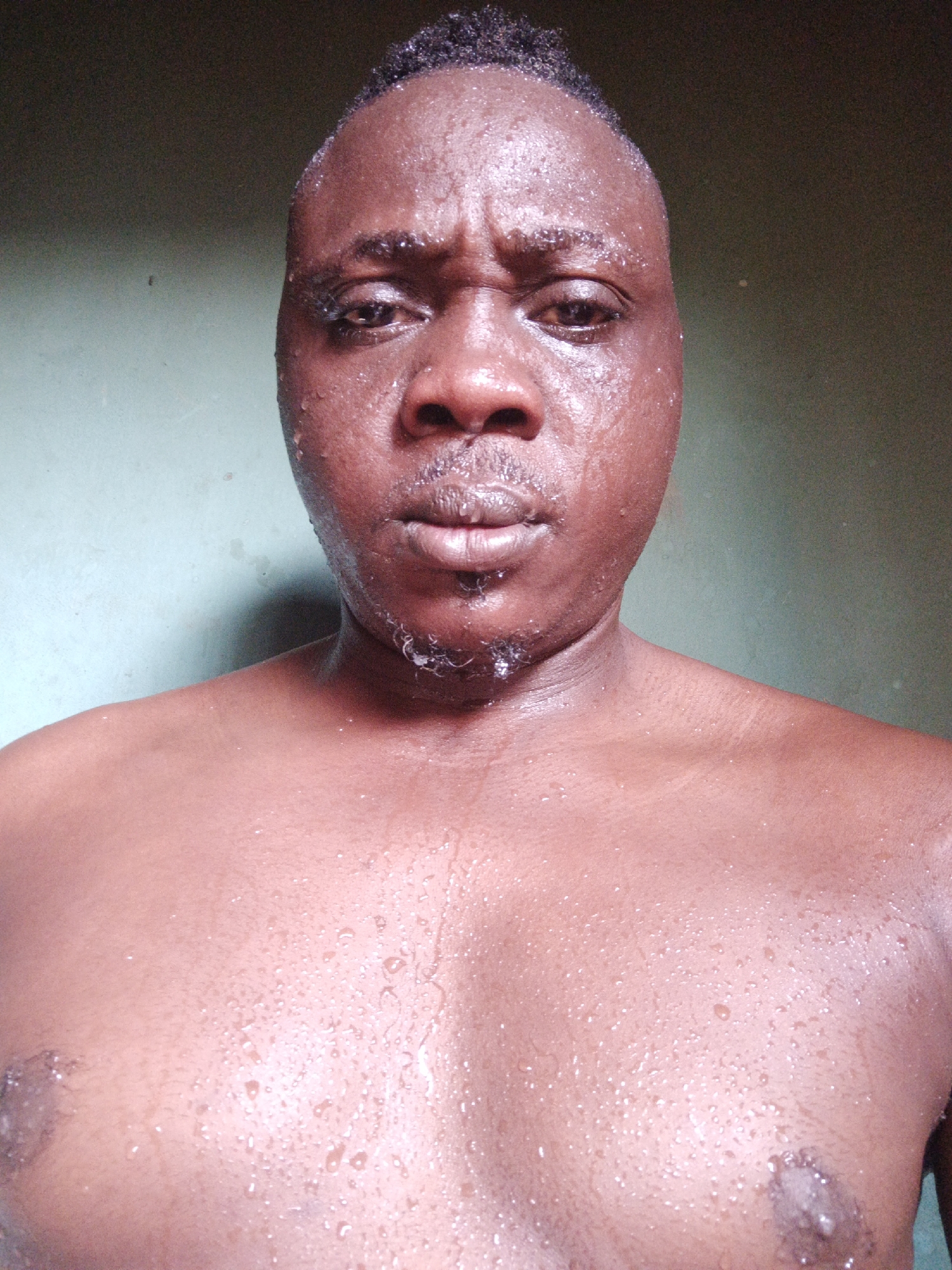 Sweaty shirtless man observed in Akwanga, Nigeria morning
