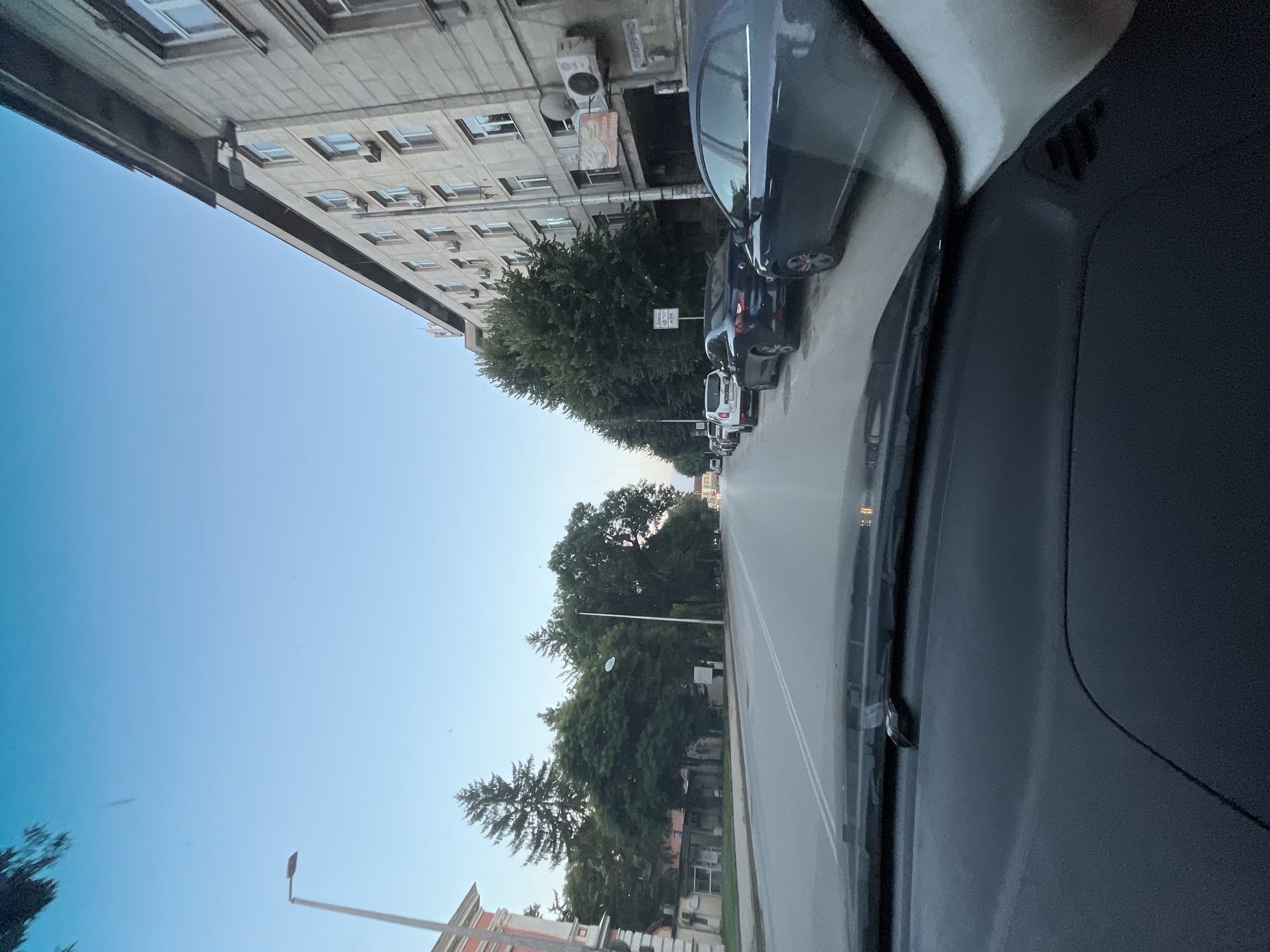 Evening drive through a city, streets and storefronts in view