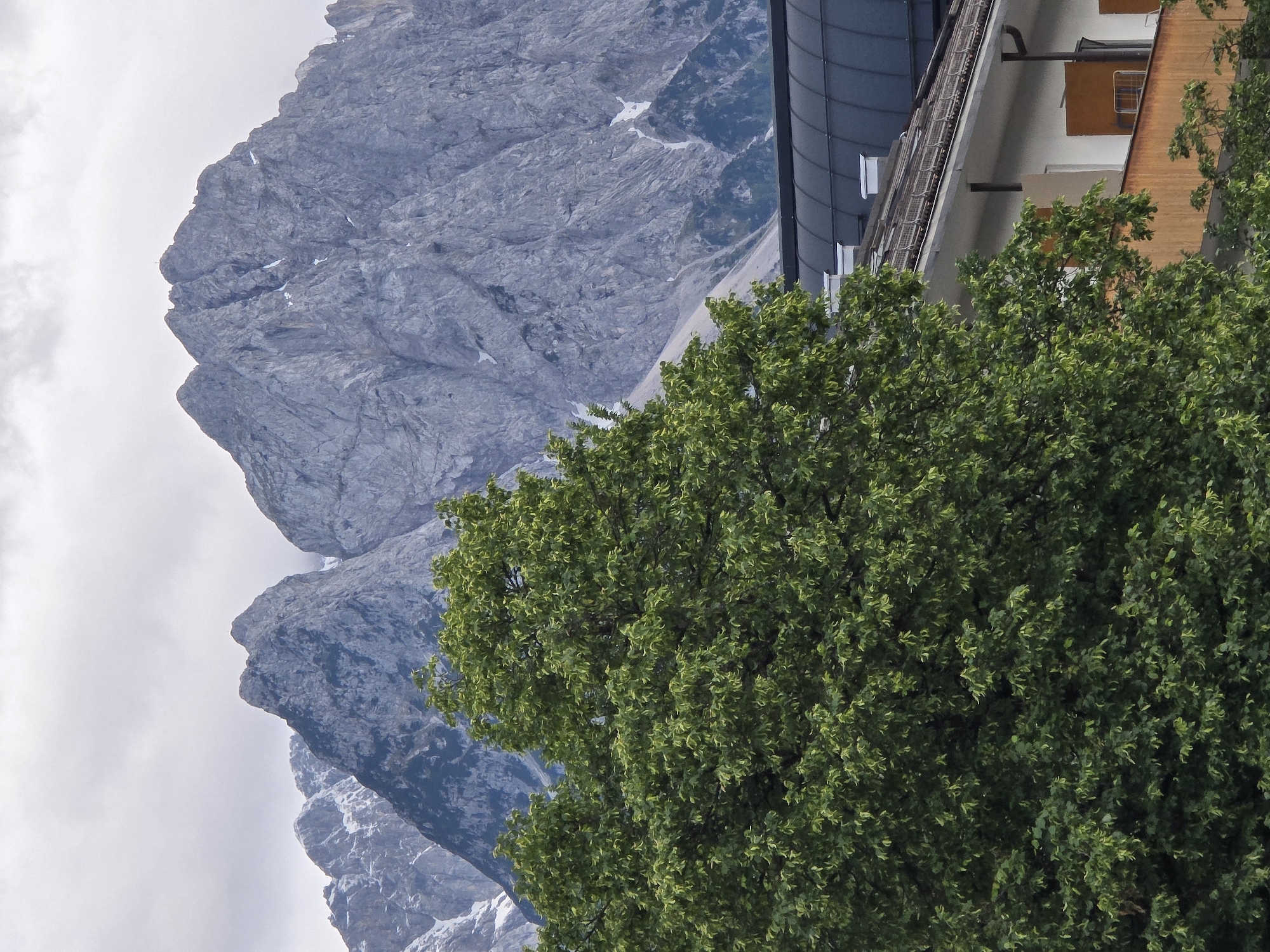 Tourist documents afternoon walk through Garmisch-Partenkirchen Alpine town
