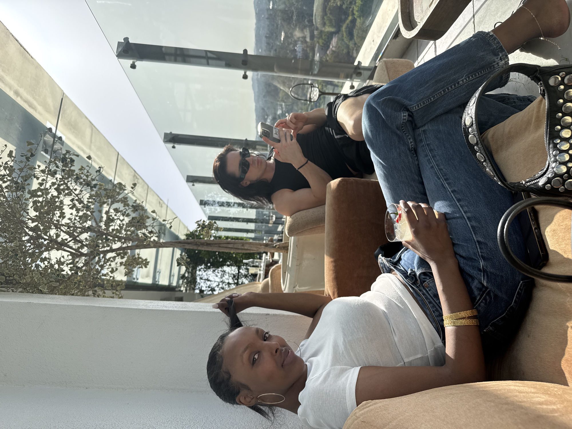Women relax at West Hollywood rooftop lounge Sunday evening