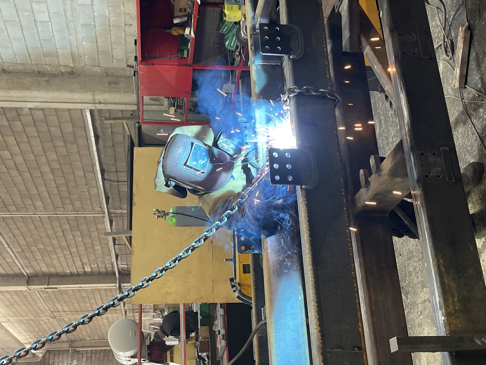 Welder performs metal fabrication work in Montenegro industrial setting