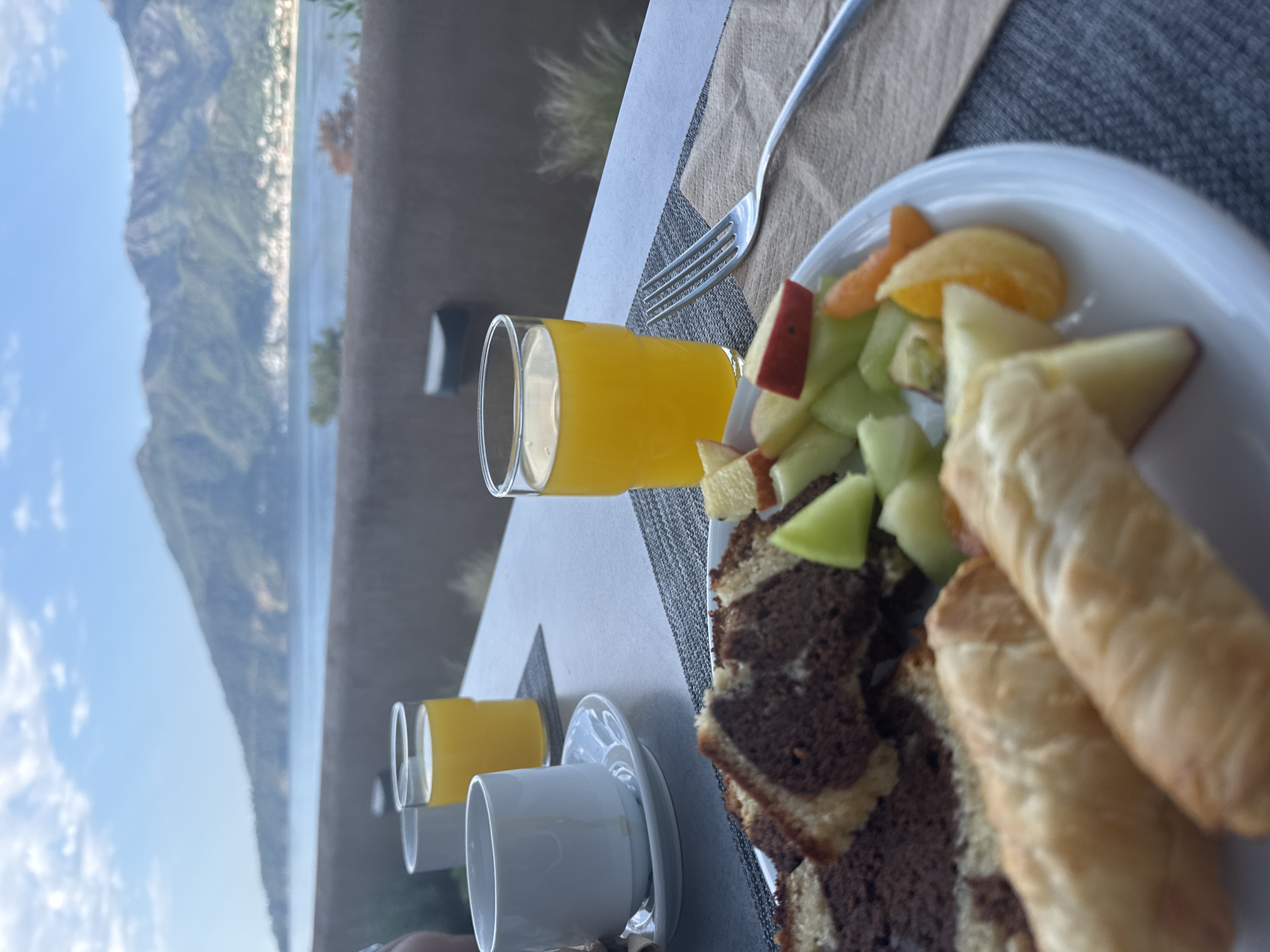 Breakfast for two set overlooking Greek coastal scenery