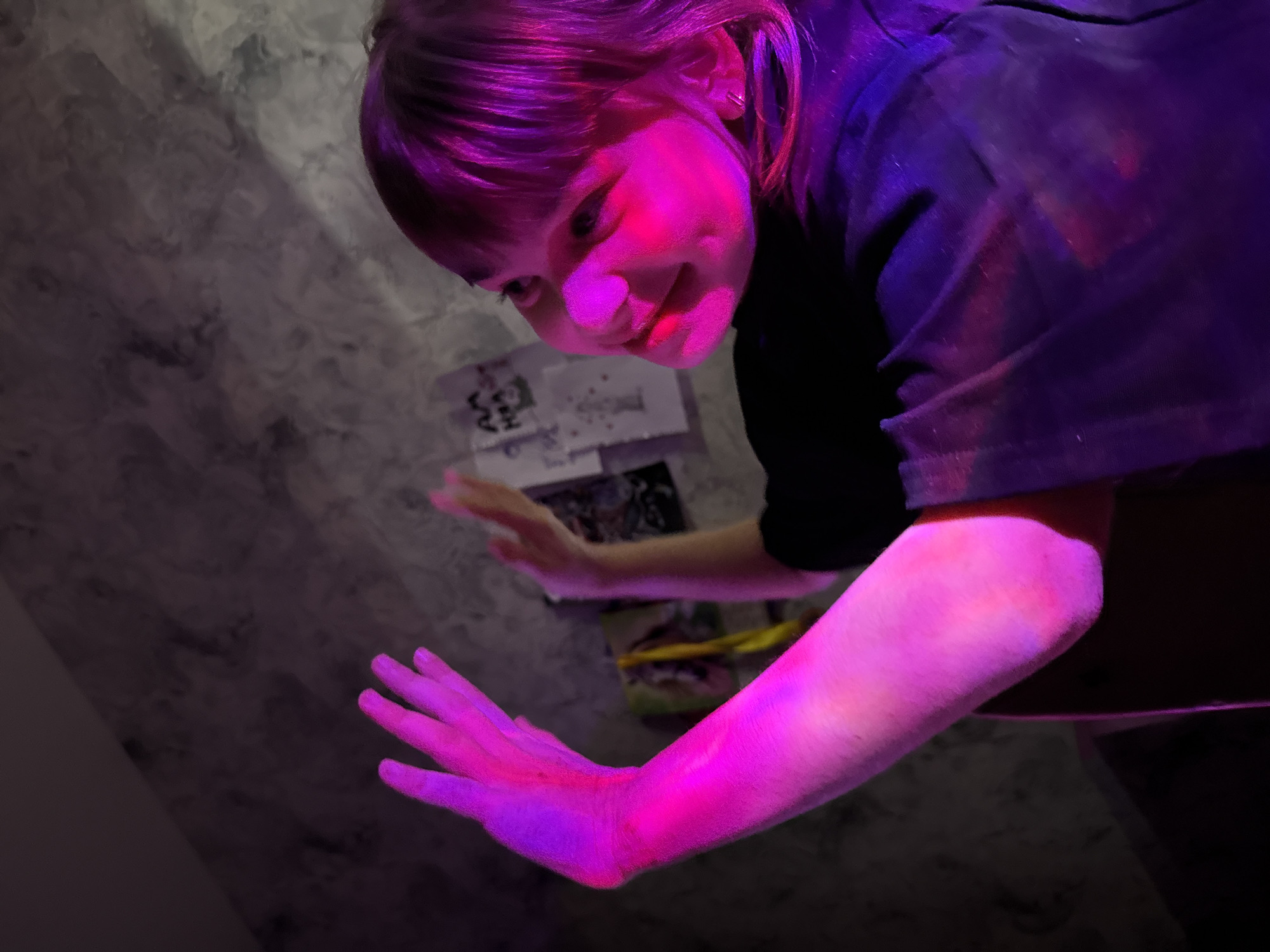 Person spotted under surreal pink-purple lighting in Rusanovo