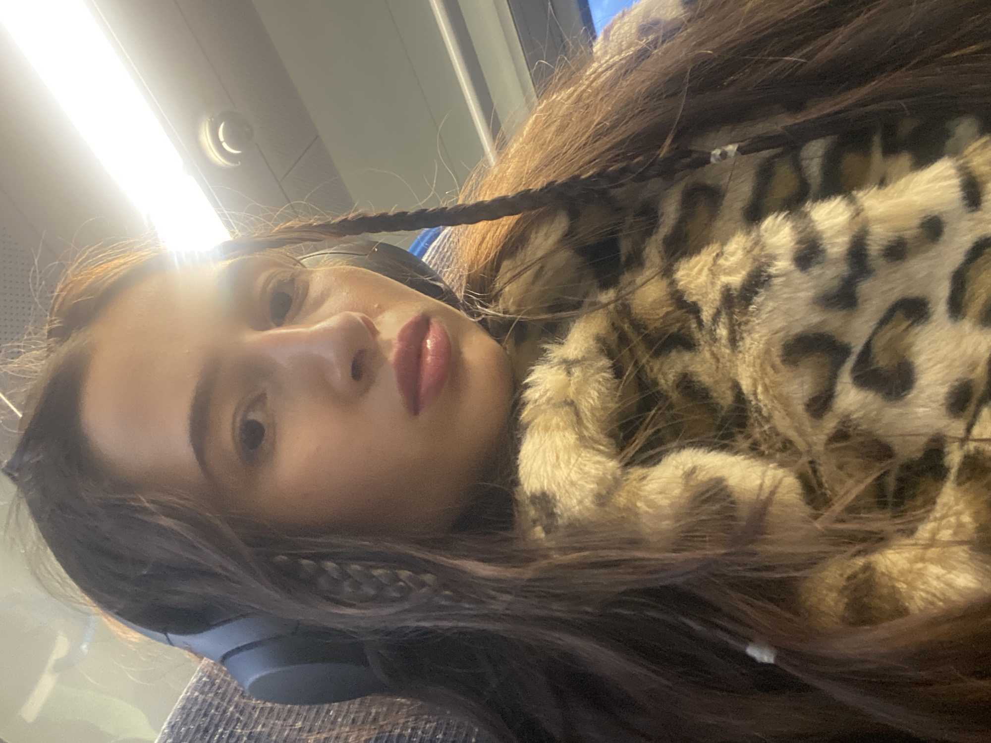 Person with headphones photographed on transport in Welwyn Hatfield