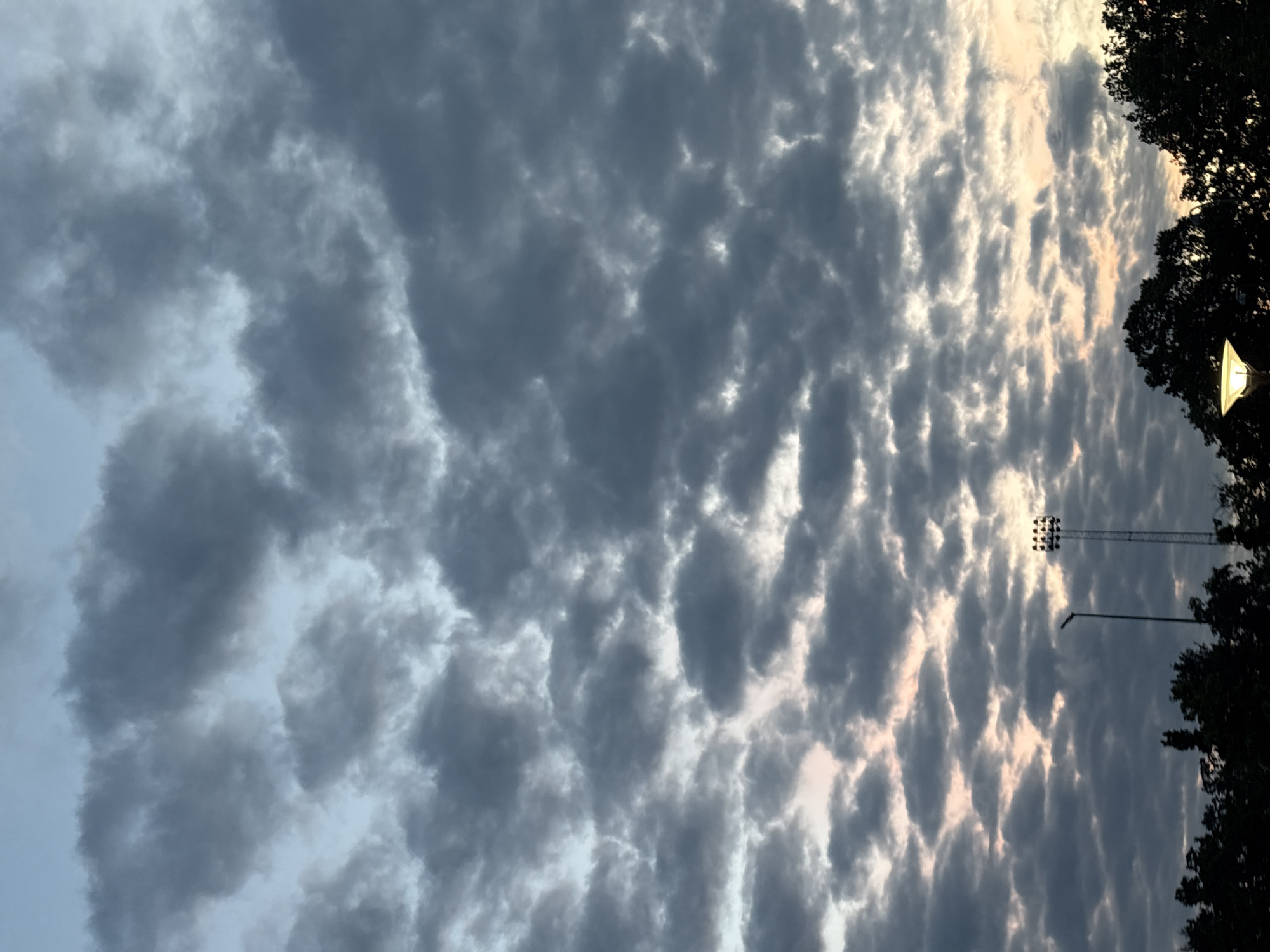 Heavy cloud cover breaks with faint light over Søborg