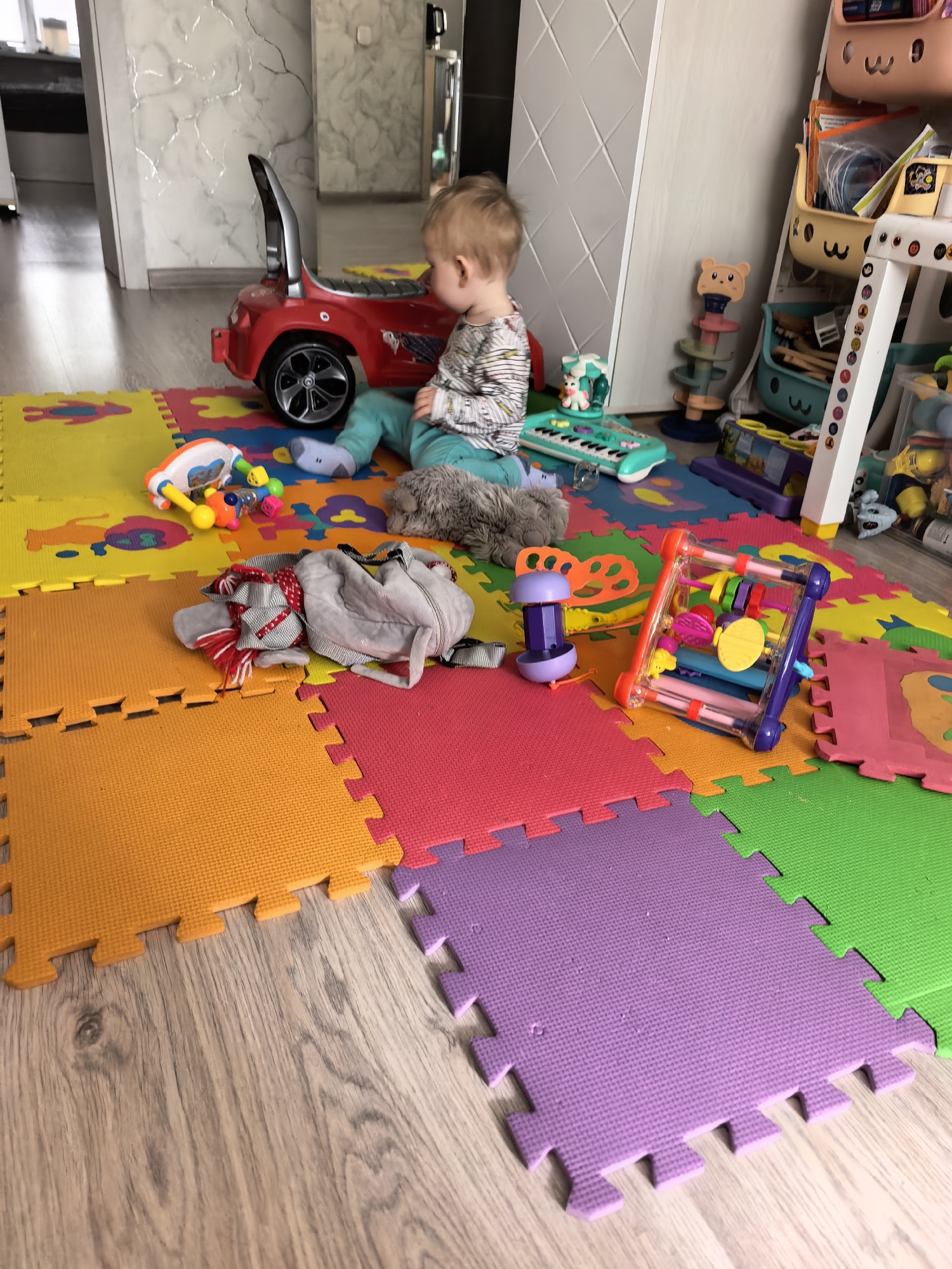 Toddler plays indoors during early morning hours in Sterlitamak
