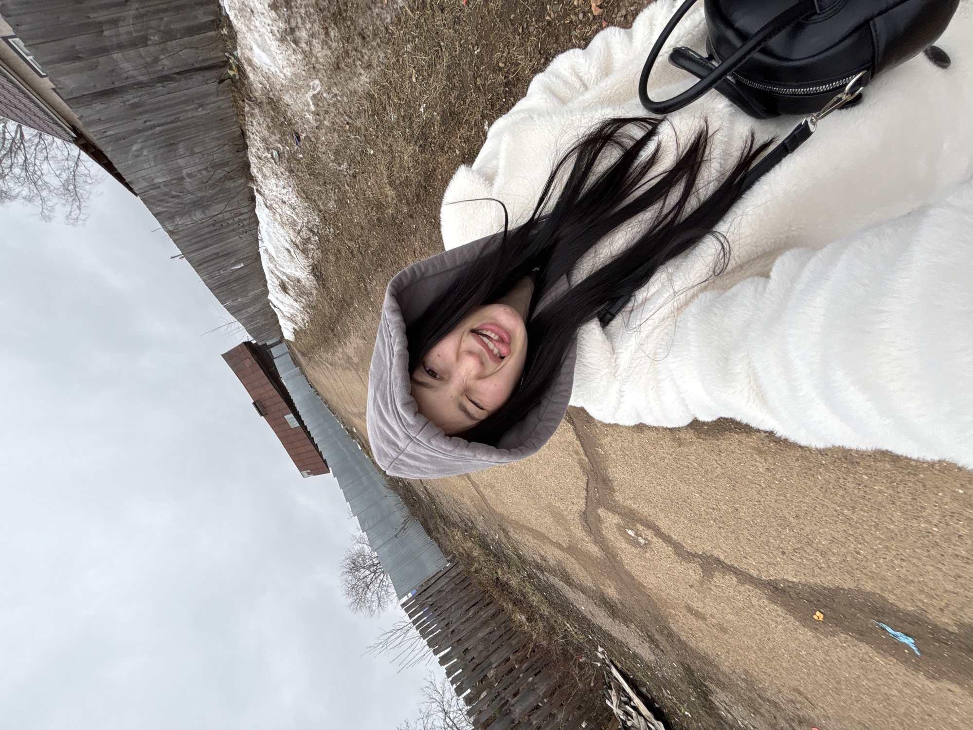 Woman takes playful selfies in wooden attic space