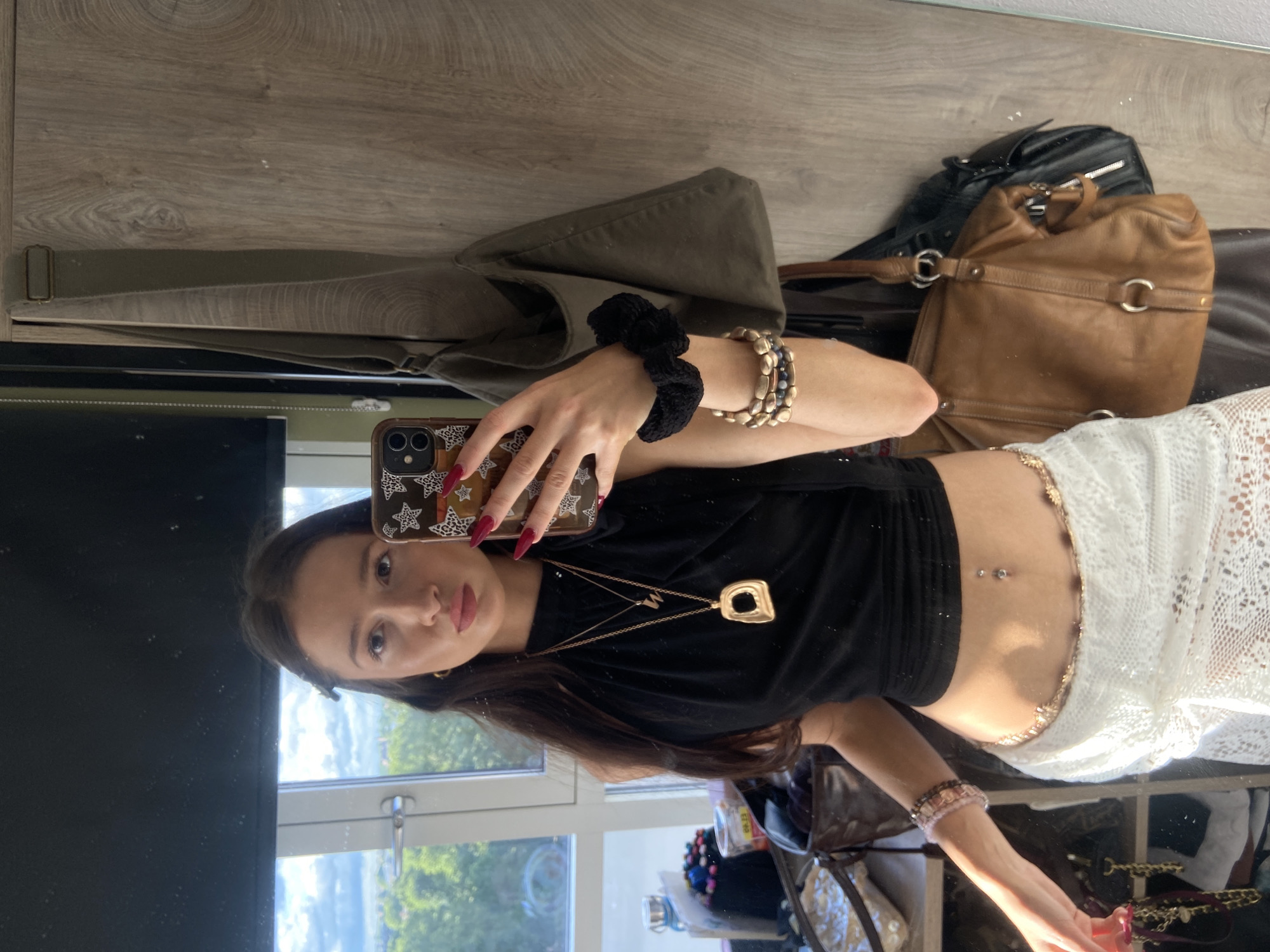Woman takes selfies, applies makeup in London room