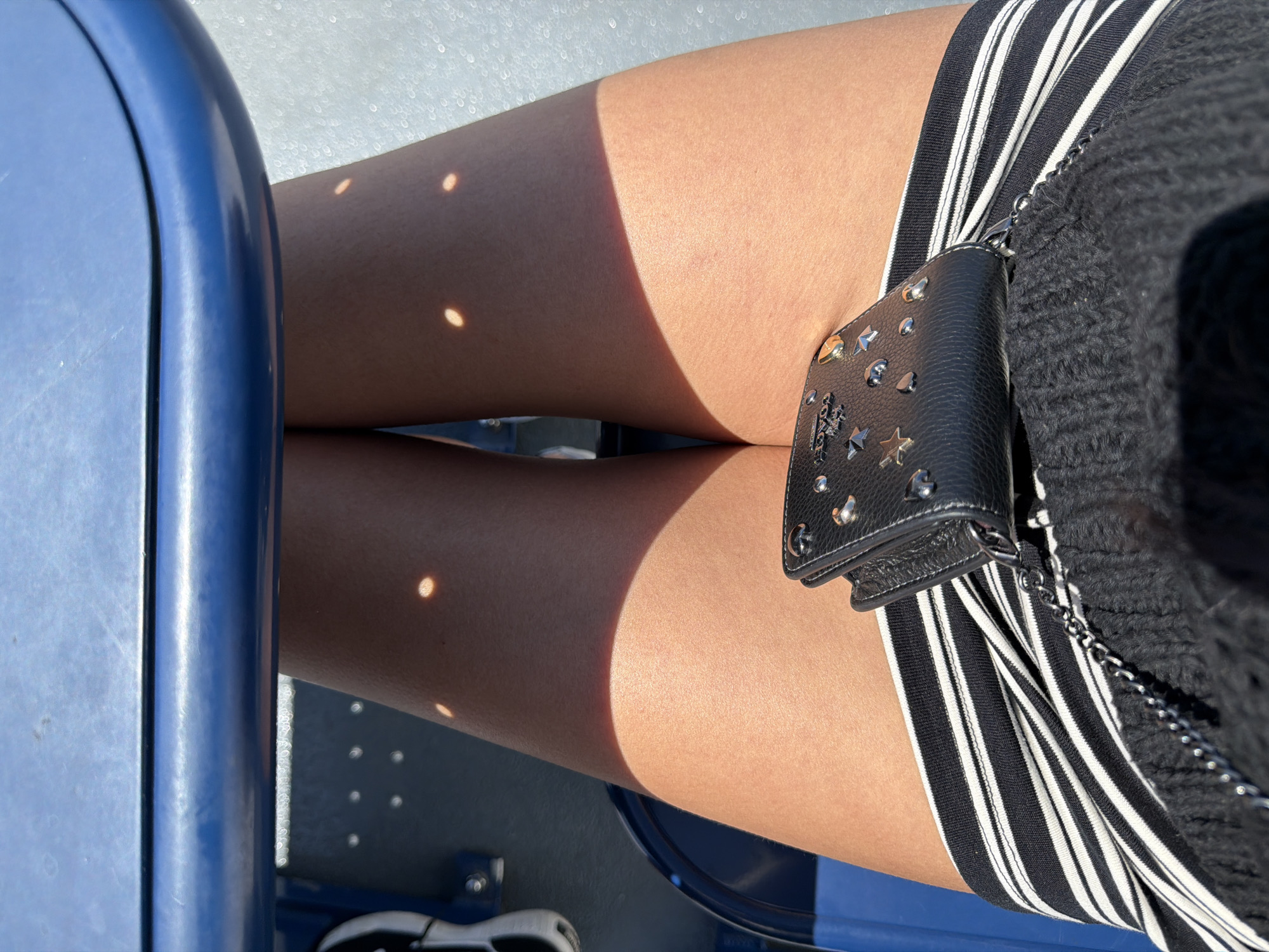 Wallet out on a blue-seated ferry in the Gulf Islands