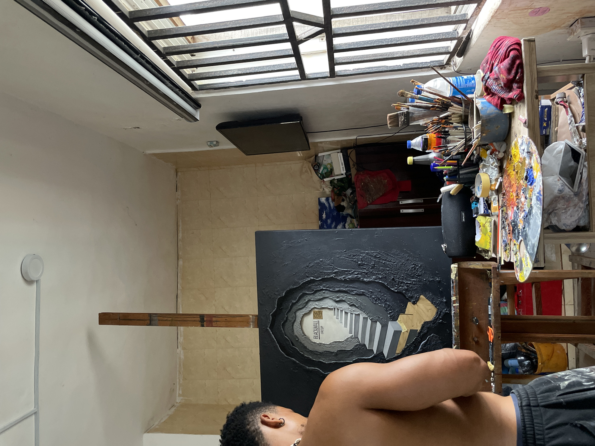 Inside an Ado artist's studio, a major canvas takes shape