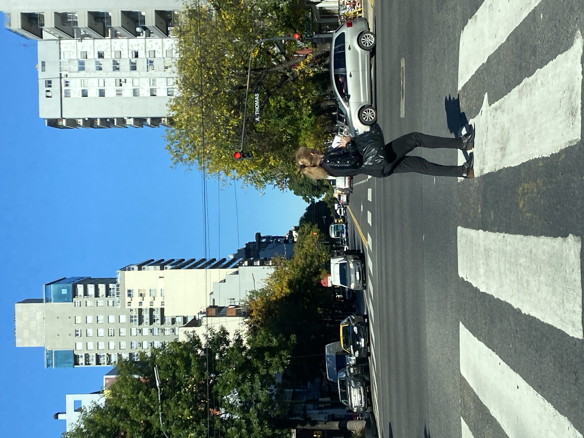 Woman crosses street on crosswalk in Buenos Aires