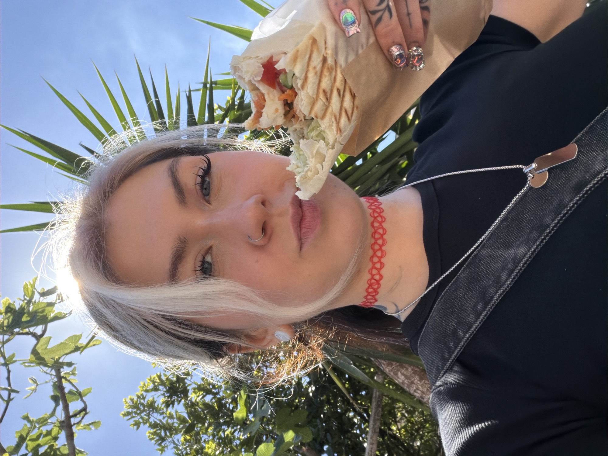 Woman enjoys shawarma lunch in Donji Pobori, Montenegro