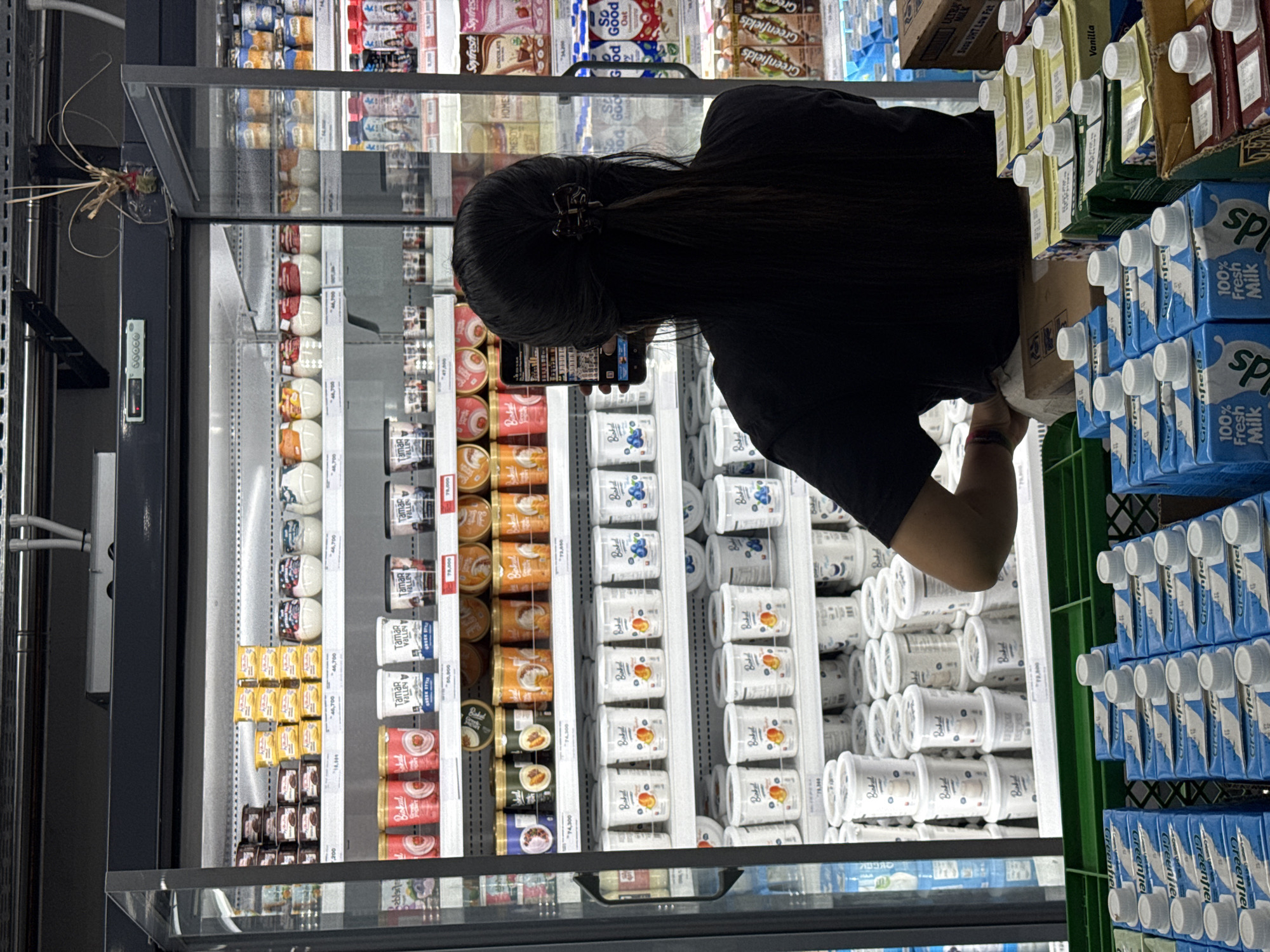 Woman shops dairy products at Petulu supermarket