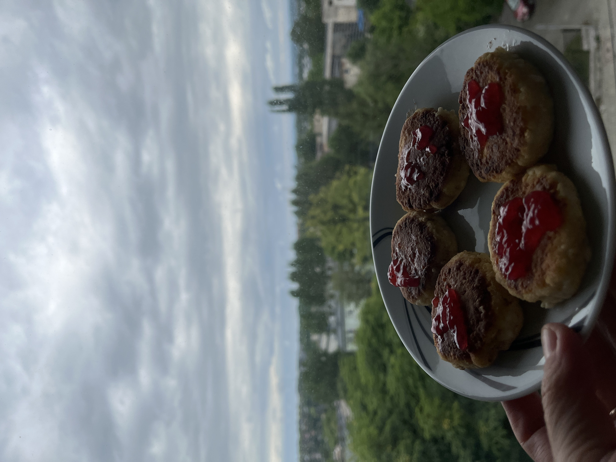Breakfast with syrniki and coffee overlooking city skyline