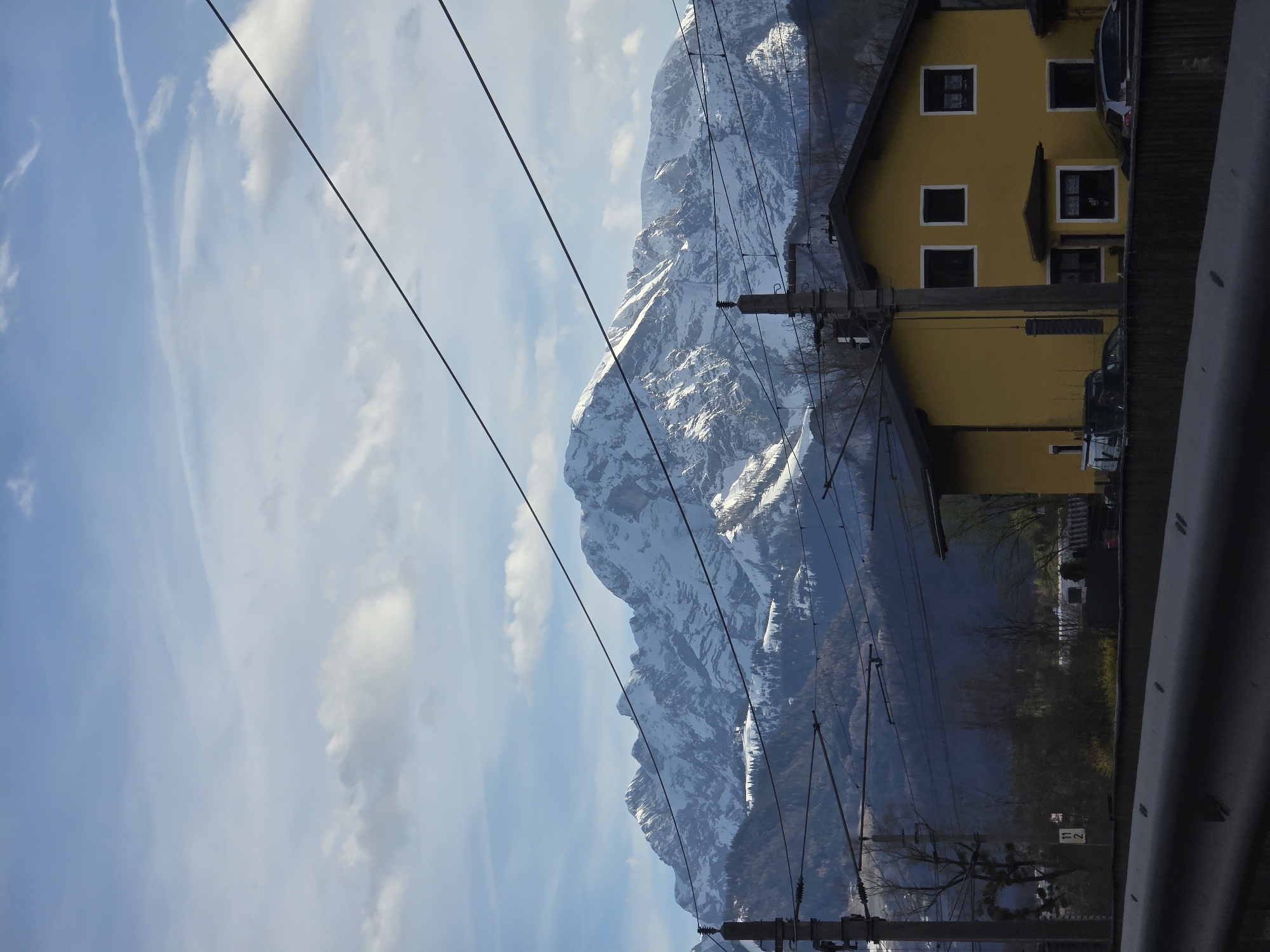 Mountain view captured through power lines in Austrian village