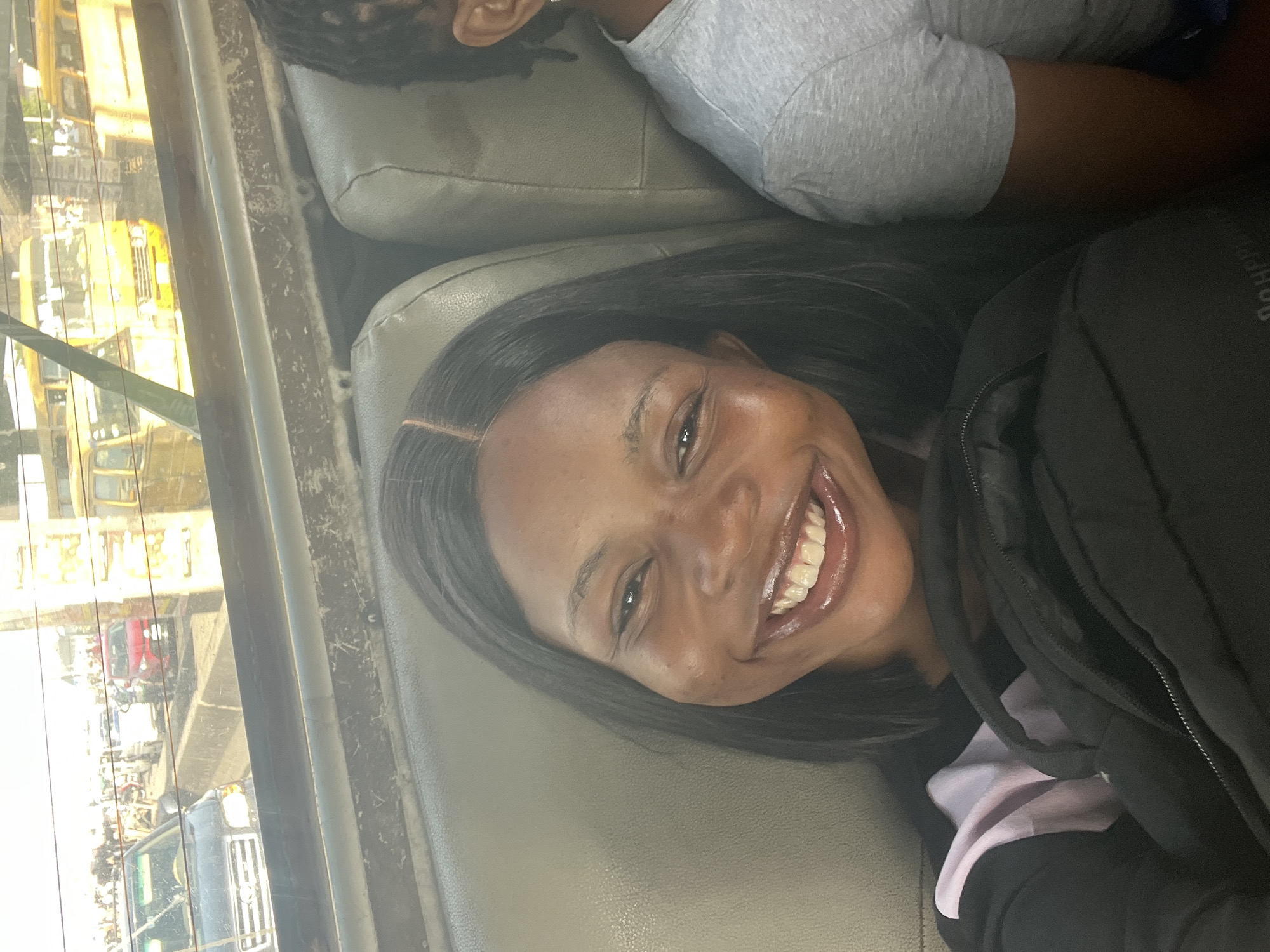 Woman photographed smiling in vehicle, Satellite Town Nigeria