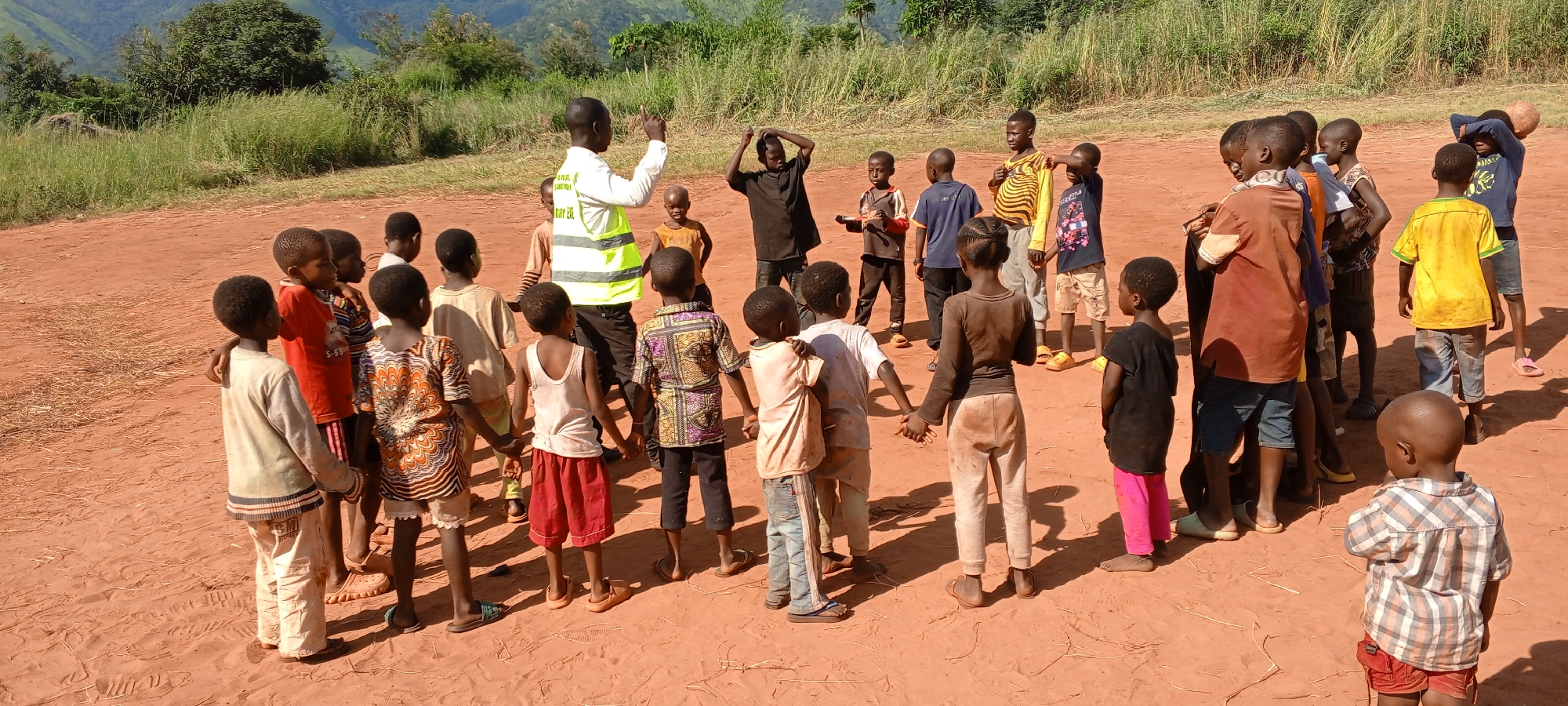 Adult leads children's activities in DRC villages