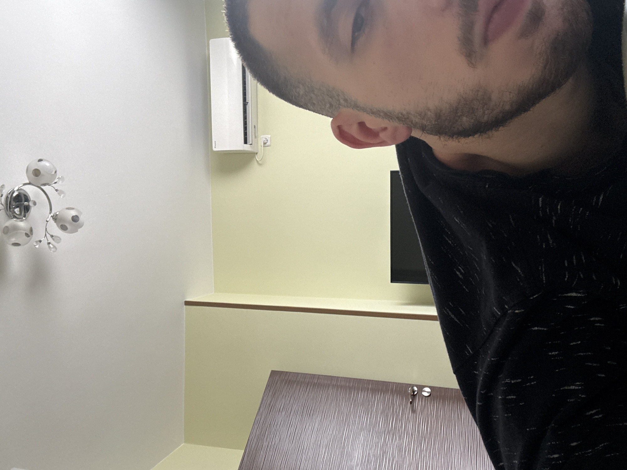 Person in hooded sweatshirt photographed indoors in Elhovo