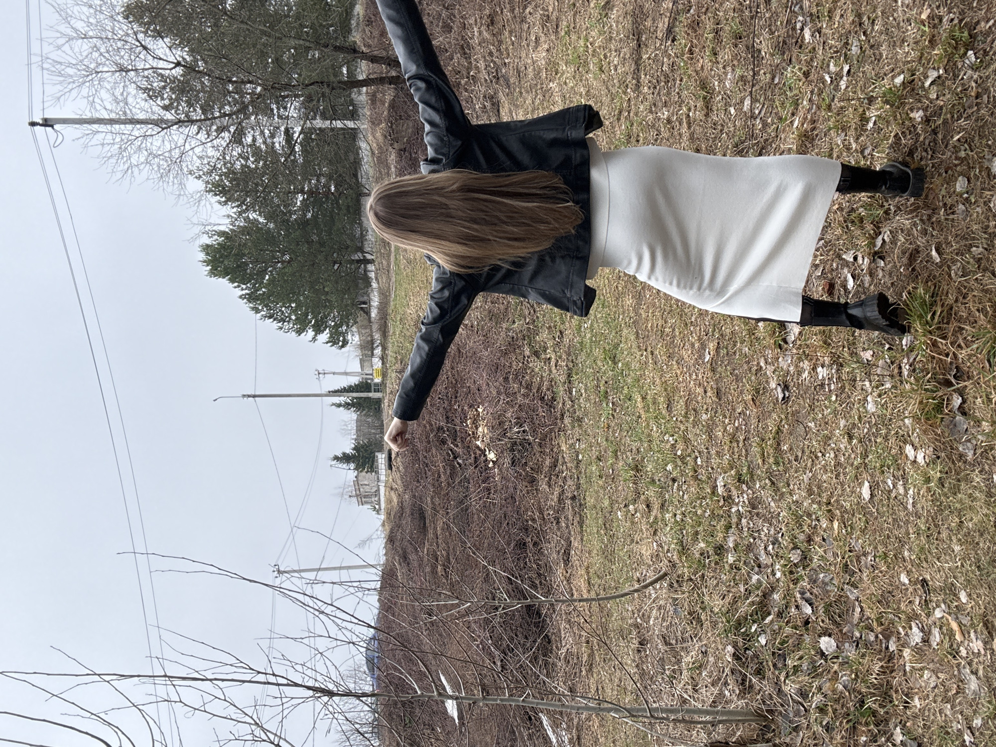 Woman photographed in field poses near Chaikovsky, Russia