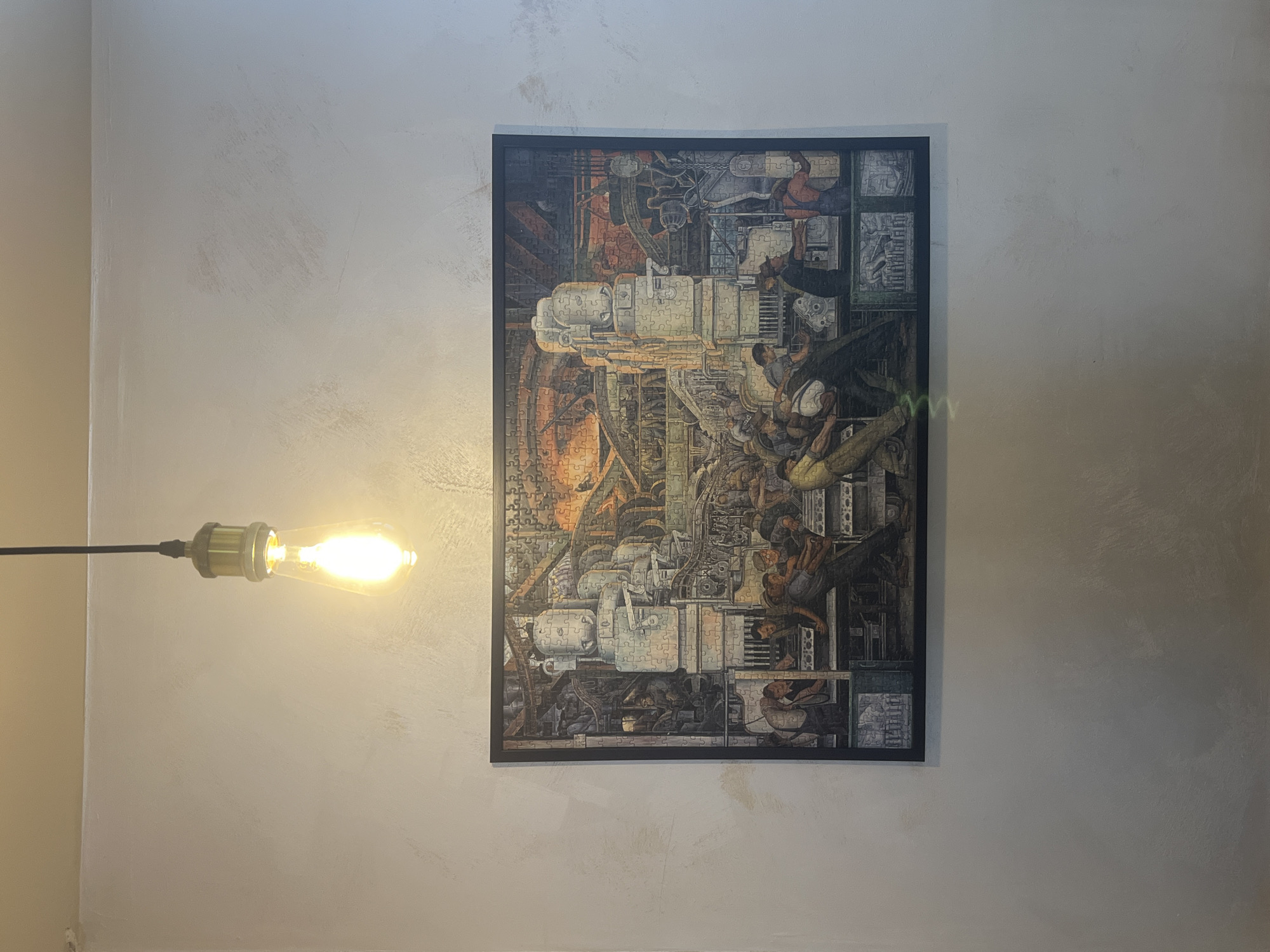Interior scene with lightbulb and puzzle-piece machinery artwork documented