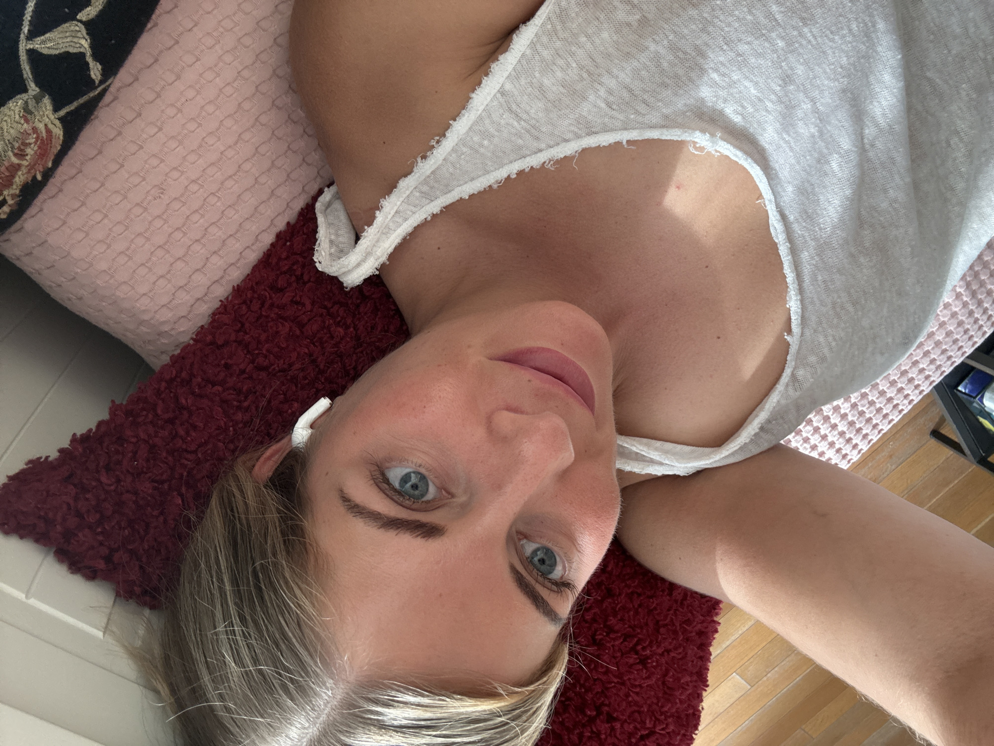 Woman rests on bed in Paris apartment