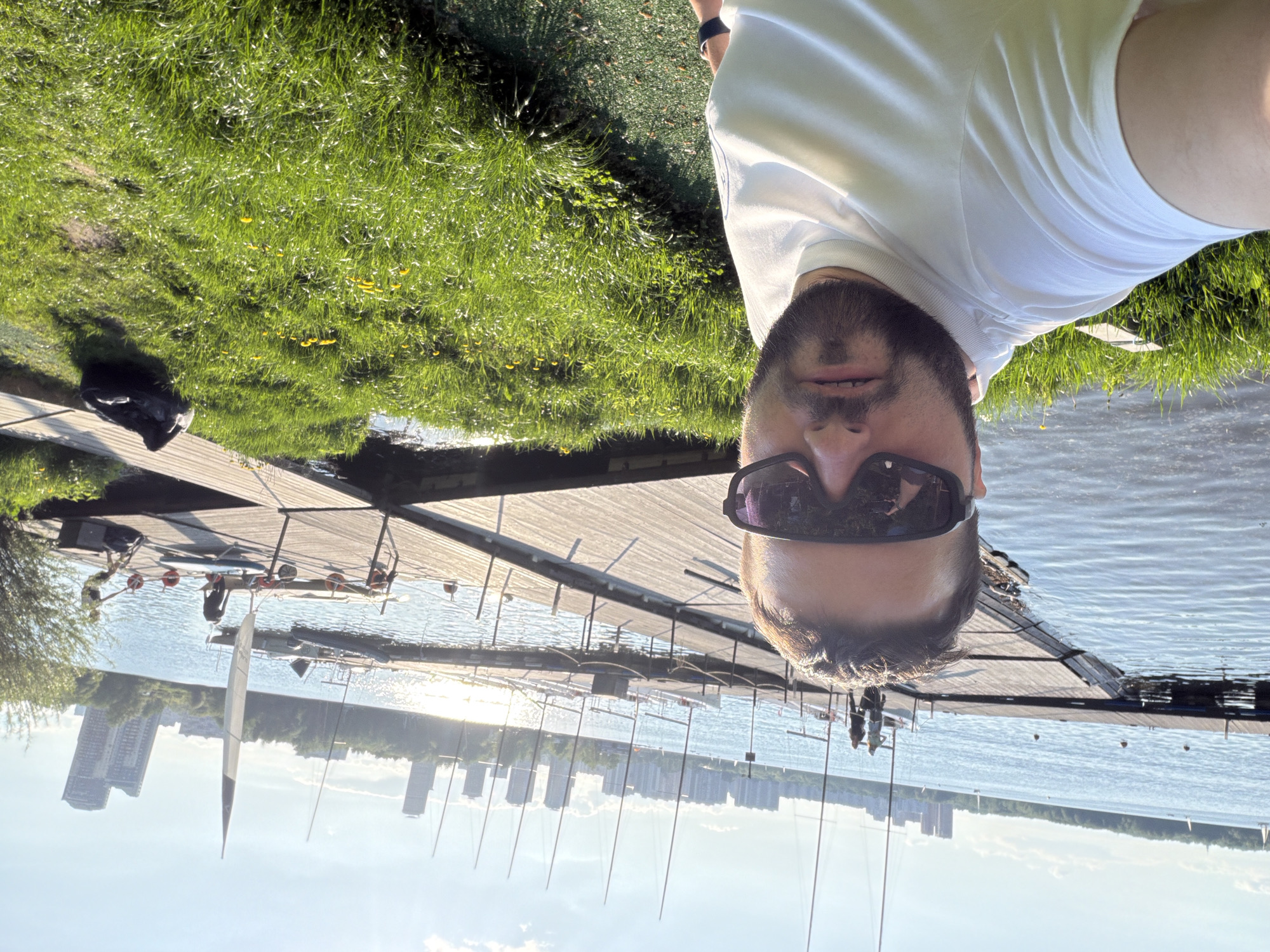 Man takes sunny selfie on wooden dock in Khimki